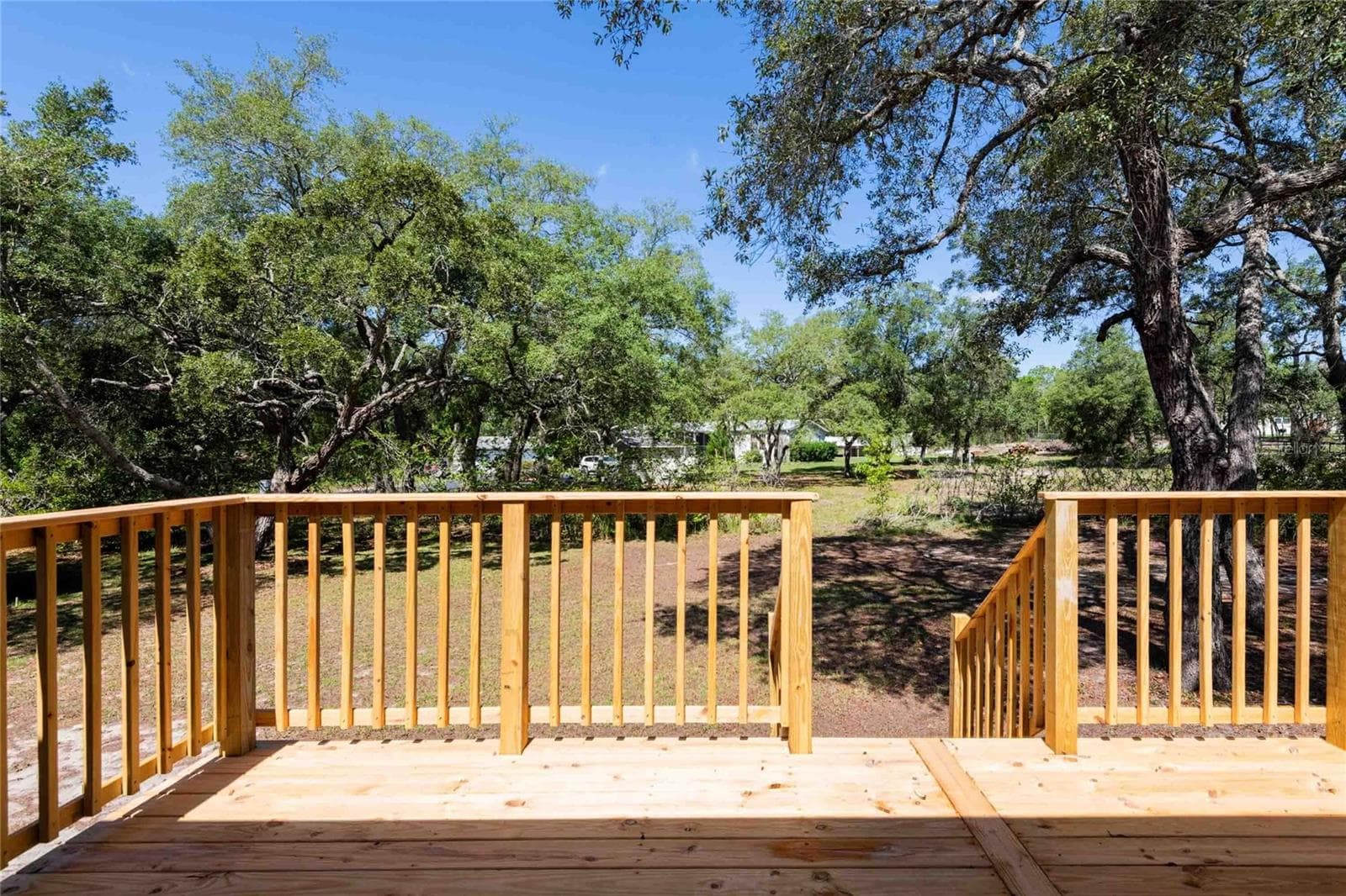 View of deck and backyard. - 14221 HURRICANE DR, WEEKI WACHEE