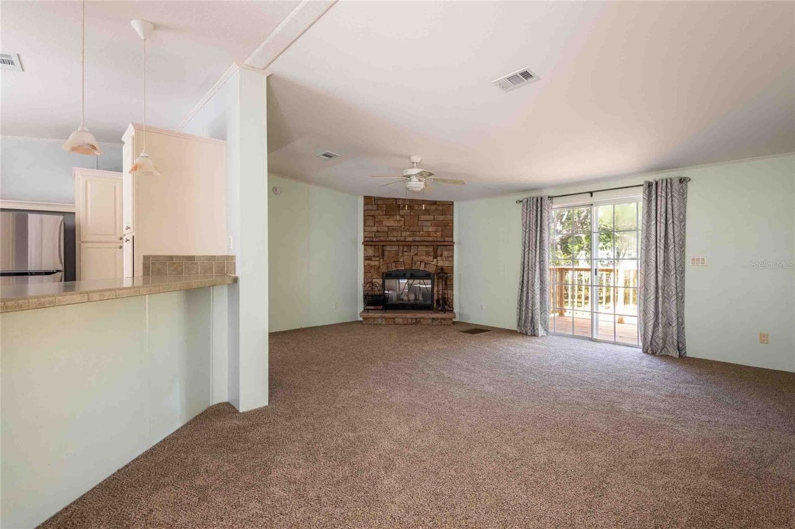 Great room with sliders to back porch deck. - 14221 HURRICANE DR, WEEKI WACHEE
