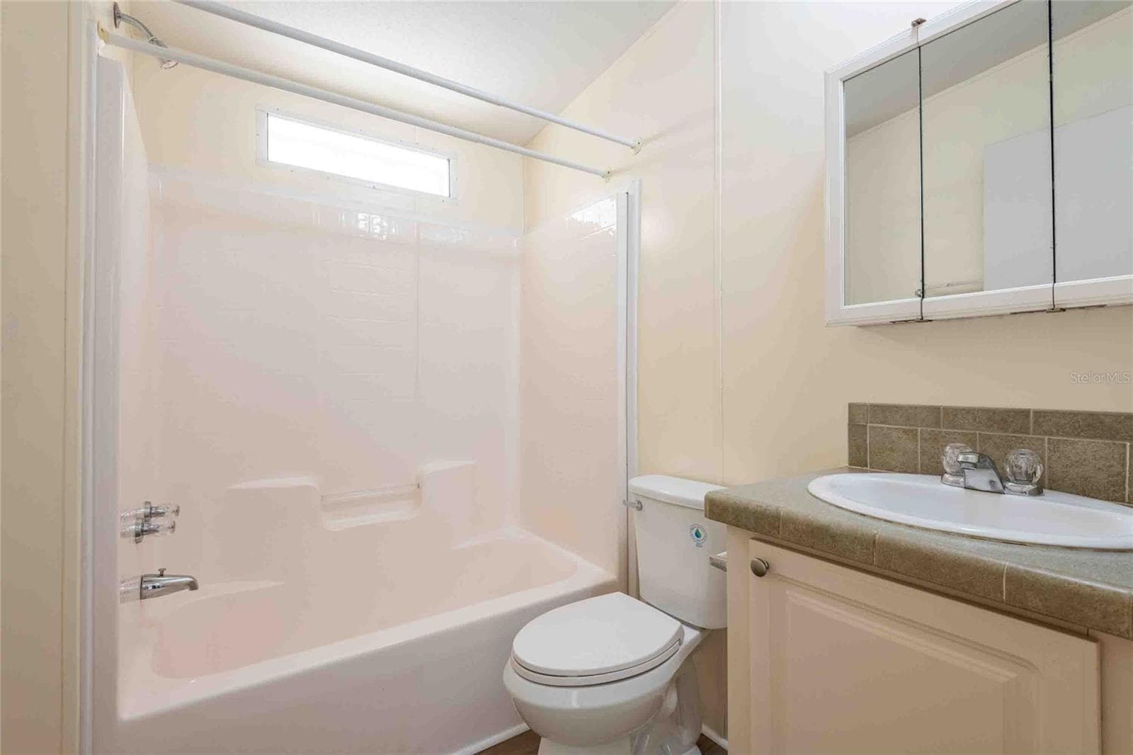 Third bathroom off of the living room and next to the 4th Bedroom. - 14221 HURRICANE DR, WEEKI WACHEE