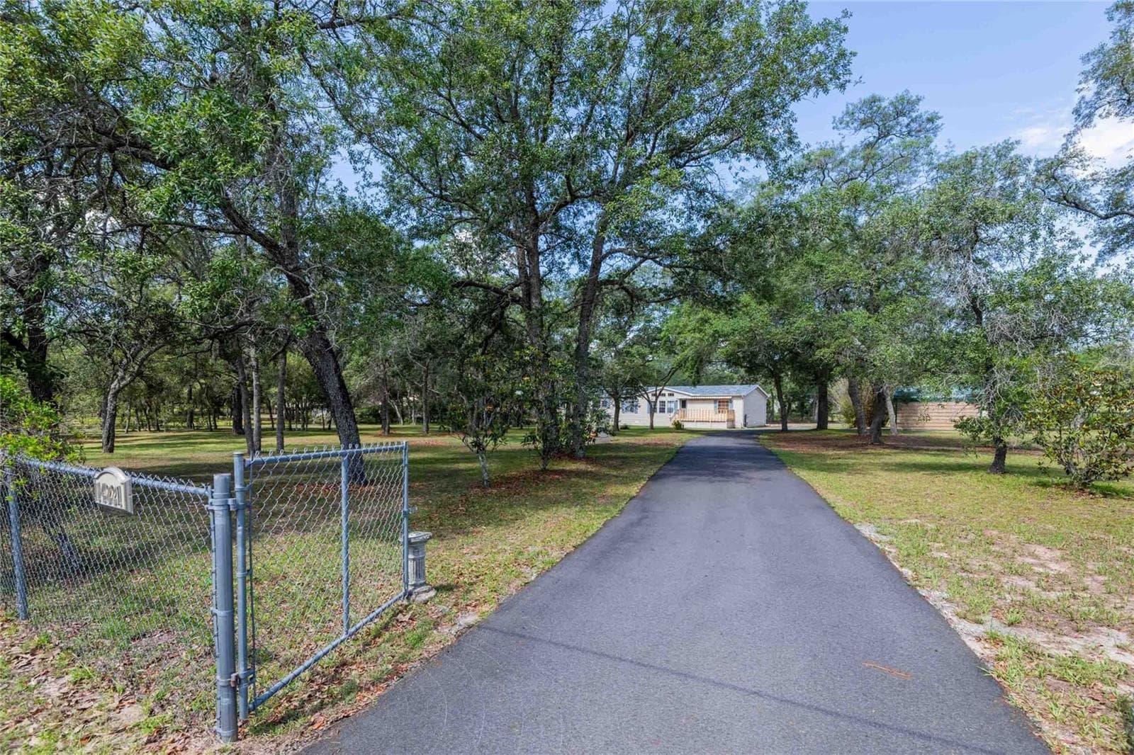Gated entrance to paved driveway - 14221 HURRICANE DR, WEEKI WACHEE