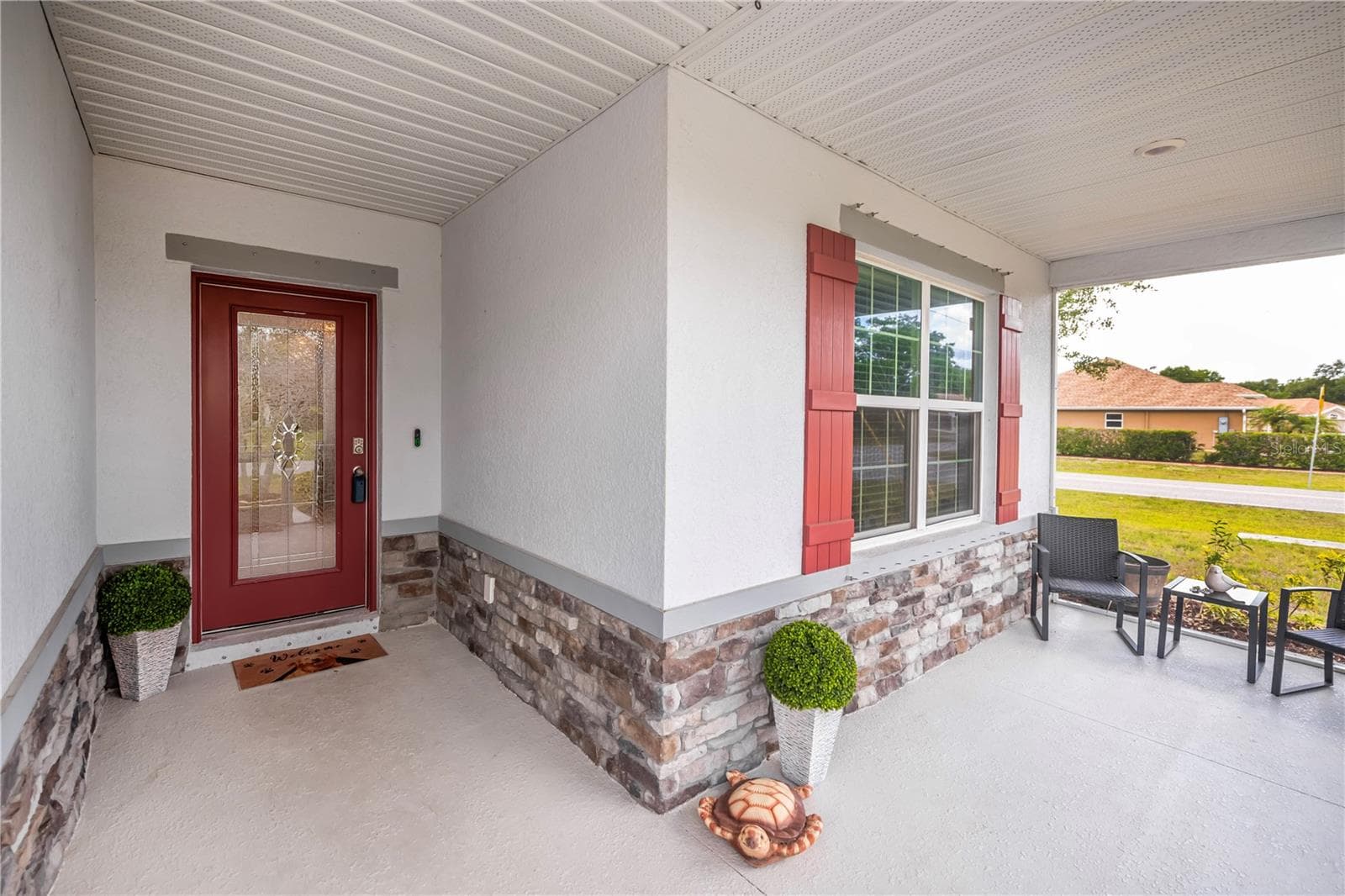 Stone Accented Screened Front Entryway with Leaded Glass Door. - 640 ENCARNACION ST, PUNTA GORDA