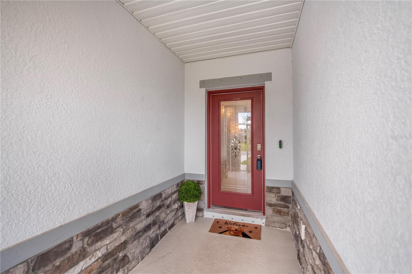Elegant Leaded Glass Front Door with Decorative Stone Accents and Screen Entry. - 640 ENCARNACION ST, PUNTA GORDA