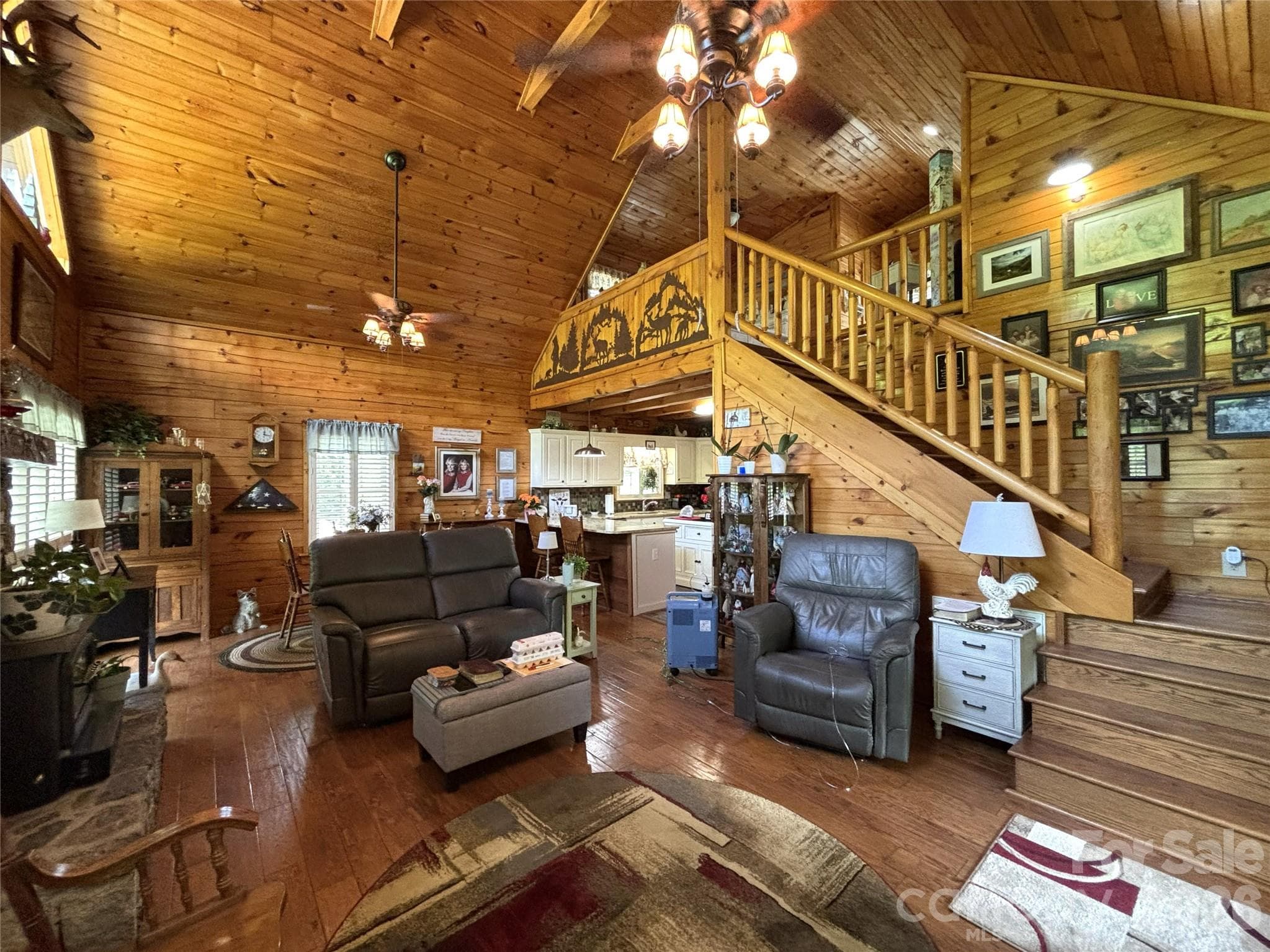 View of the living room, from where the access to the upper level is visible. - Maggie Valley
