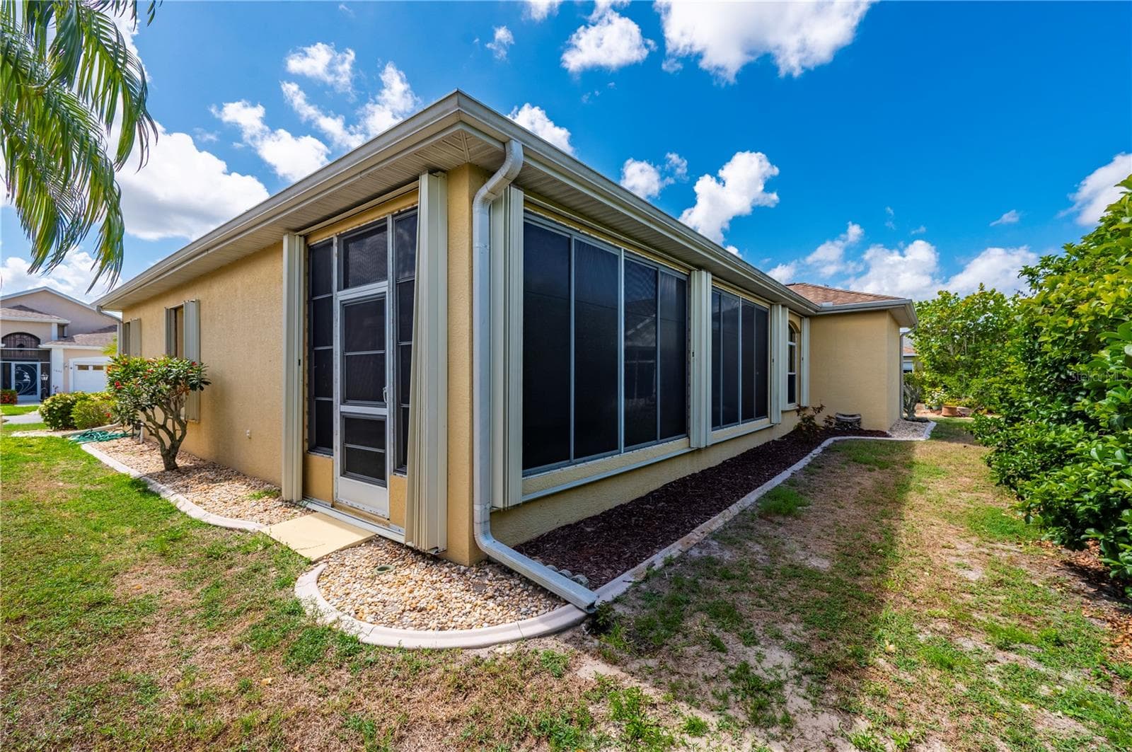 Back and side yard, gutters, curbed landscaping - 1637 PALACE CT, PORT CHARLOTTE
