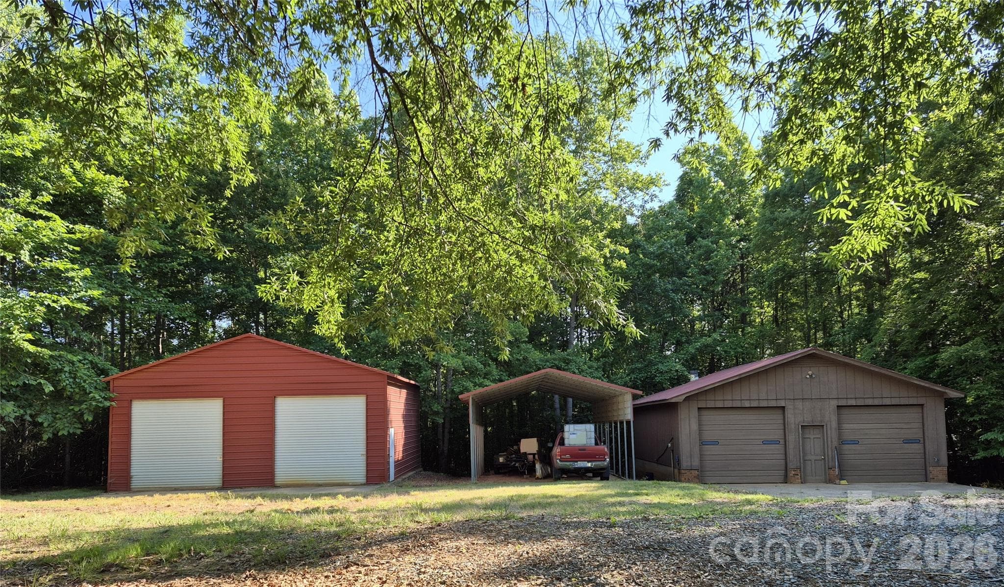 Steel garage with side entrance, detached carport, workshop with woodburning stove and bathroom. - 390 Low Water Bridge Road, Troy