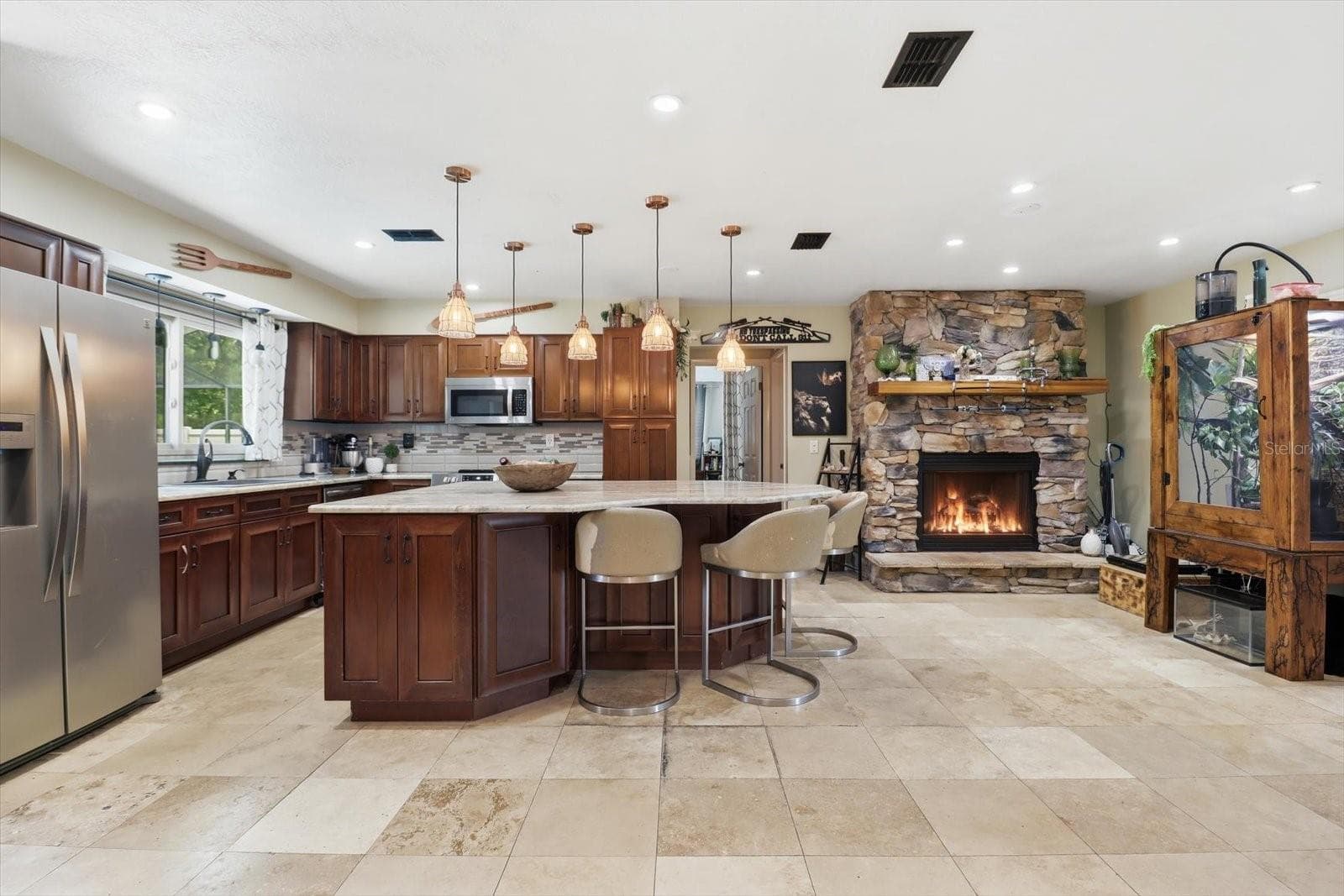 Living area & kitchen - complete with a stone gas fireplace - 8720 N TROJAN DR, CITRUS SPRINGS