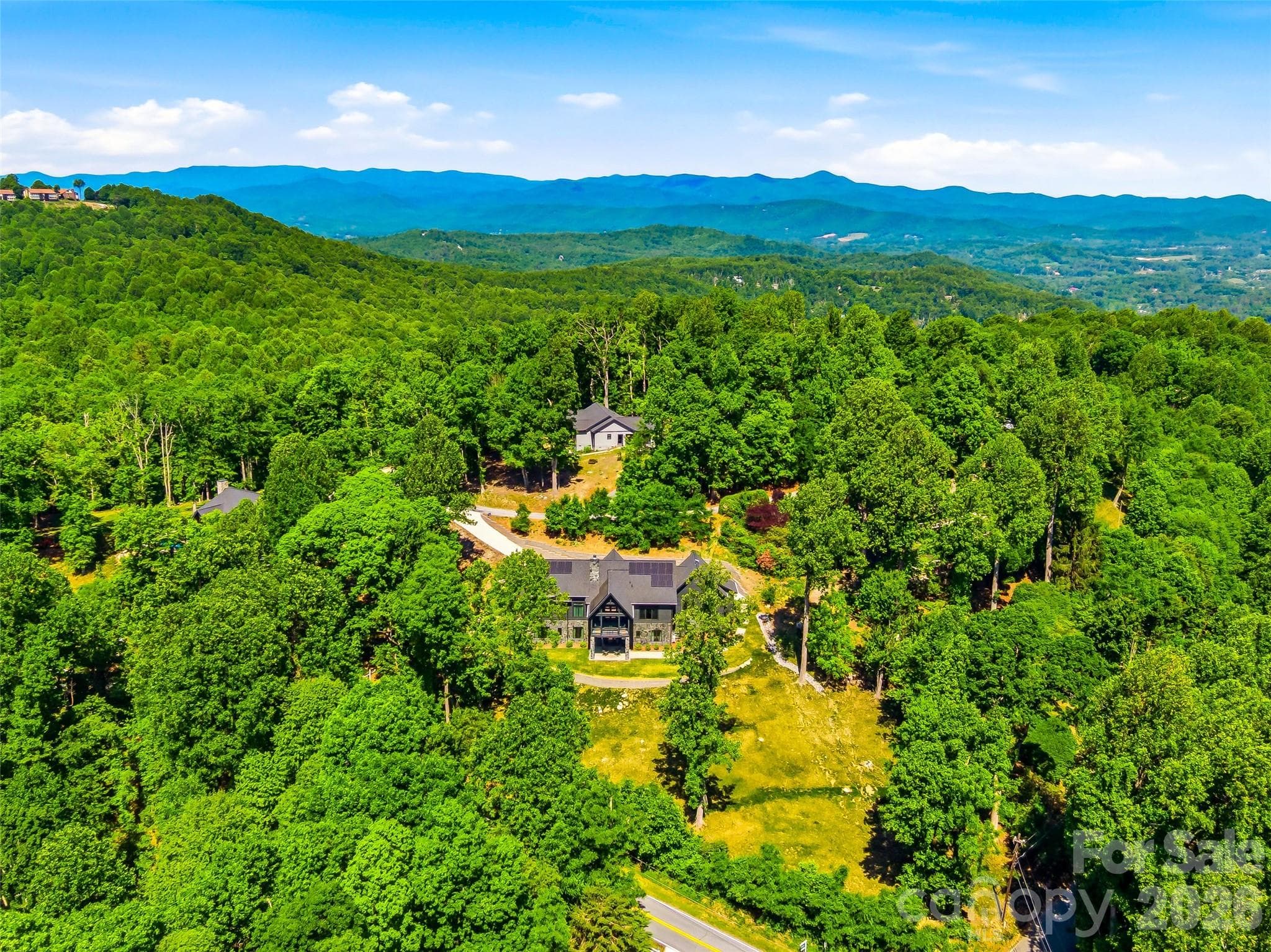 Bird’s-eye perspective highlighting the home’s elevated position and surrounding landscape - 241 Tower Circle, Hendersonville