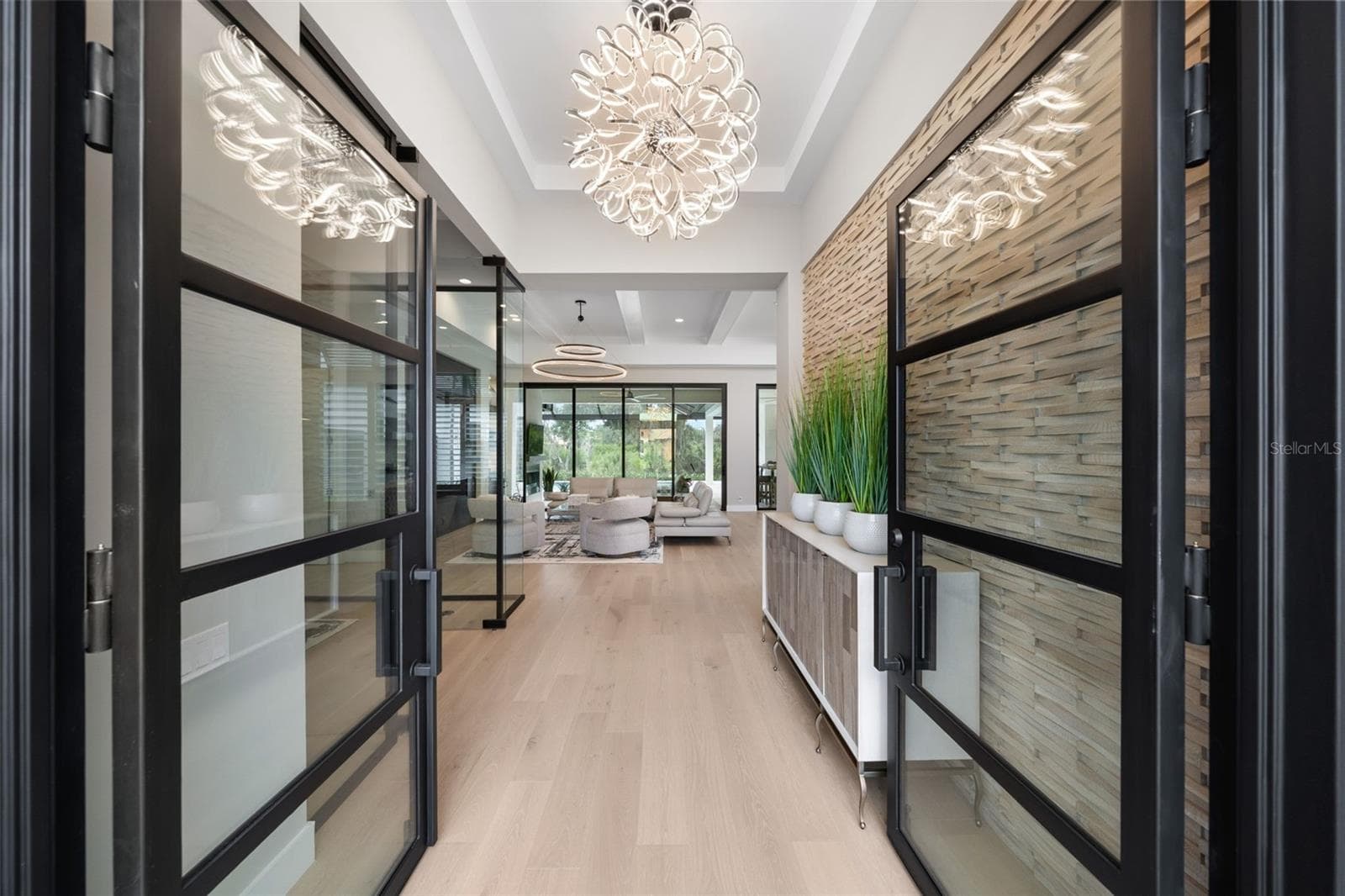 The architectural presence of the home is immediately evident as you enter the foyer through breathtaking 10-foot glass and iron entry doors. - 11721 RIVE ISLE RUN, PARRISH