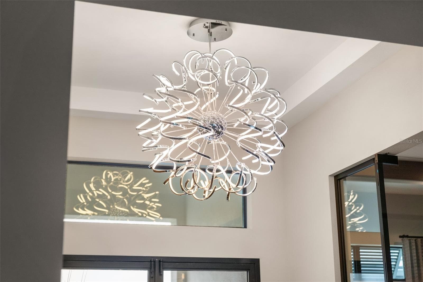 The foyer has soaring ceilings and designer lighting. - 11721 RIVE ISLE RUN, PARRISH