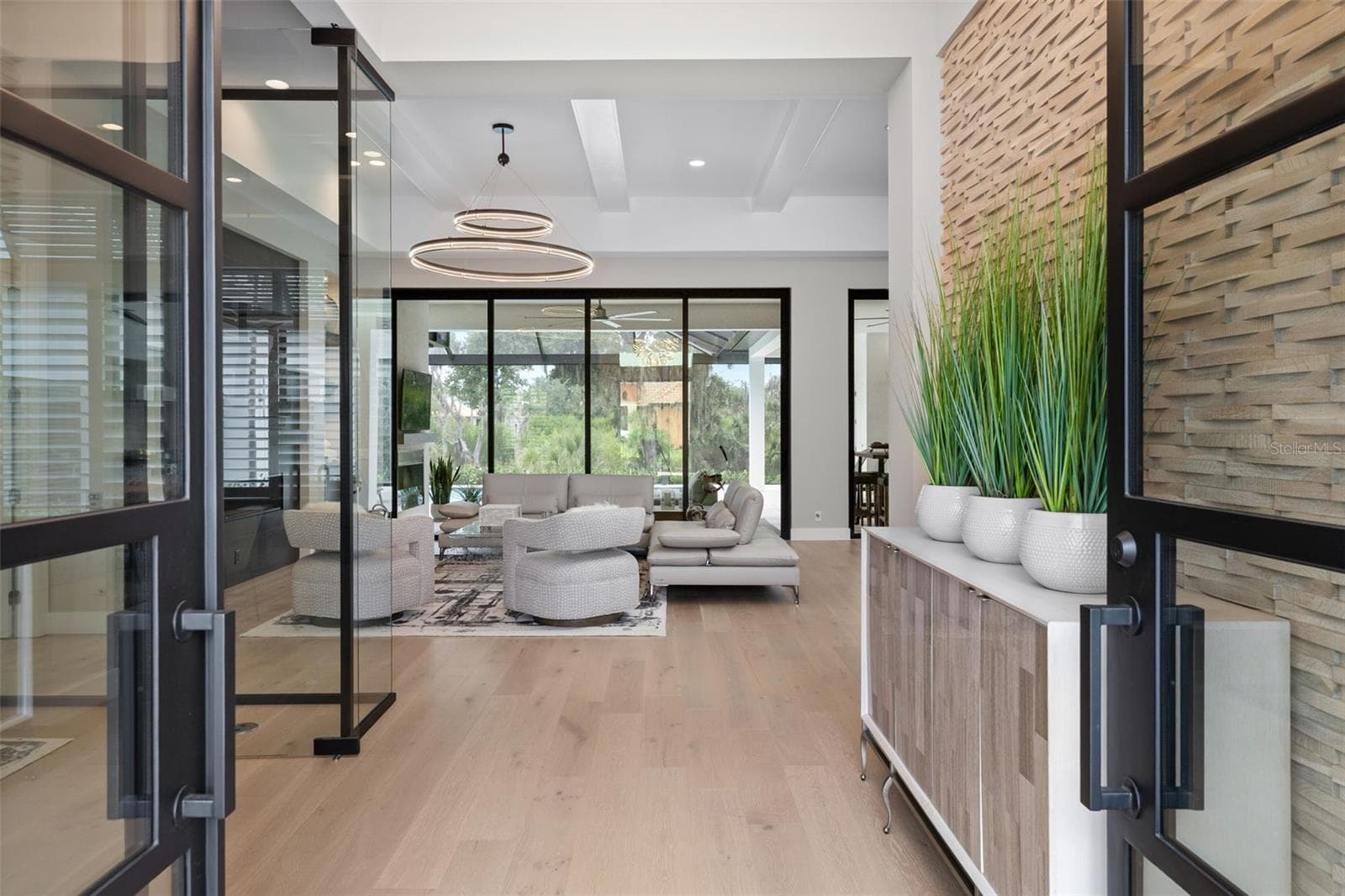 Inside, rich wood flooring flows seamlessly throughout. - 11721 RIVE ISLE RUN, PARRISH