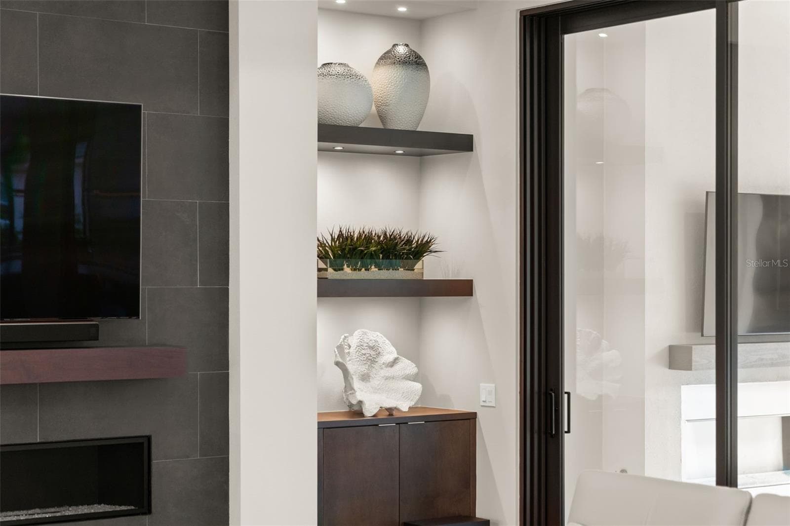 The custom built-in cabinetry and shelving has accent lighting. - 11721 RIVE ISLE RUN, PARRISH