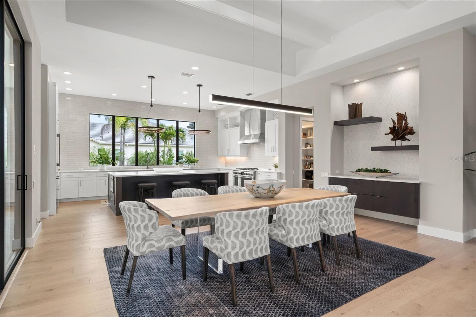 It is designed to create a dramatic backdrop for intimate dinners and larger gatherings alike. - 11721 RIVE ISLE RUN, PARRISH