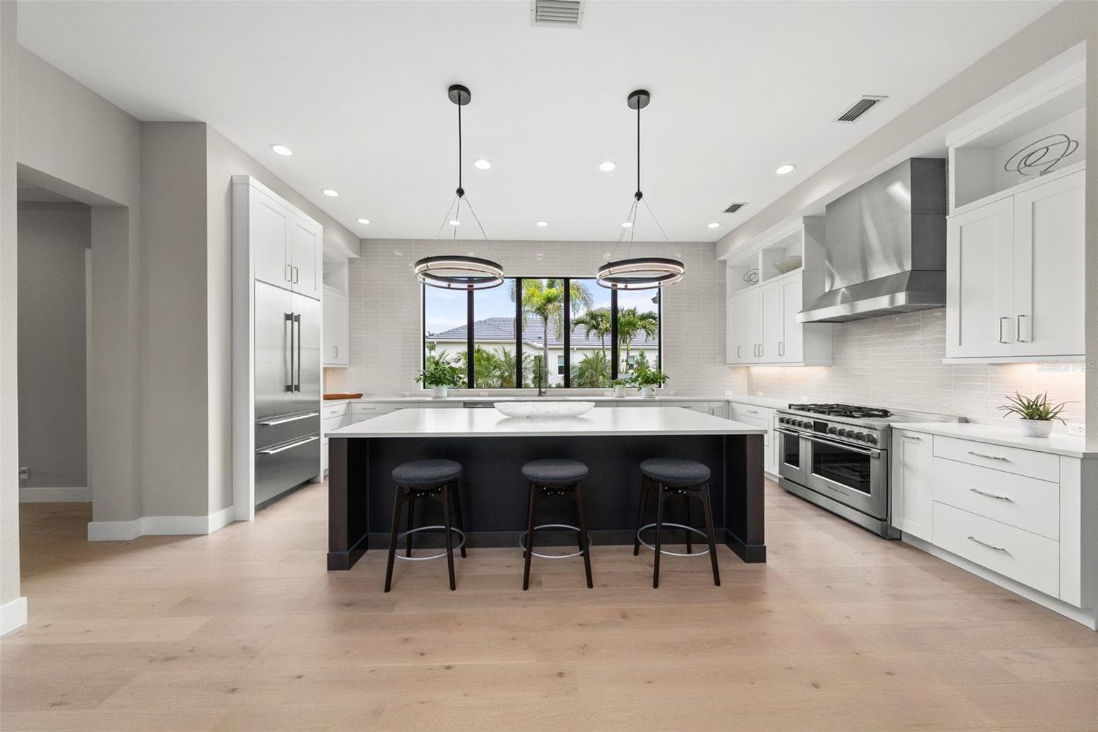 The heart of the home is the chef’s kitchen, thoughtfully designed for entertaining and everyday enjoyment. - 11721 RIVE ISLE RUN, PARRISH