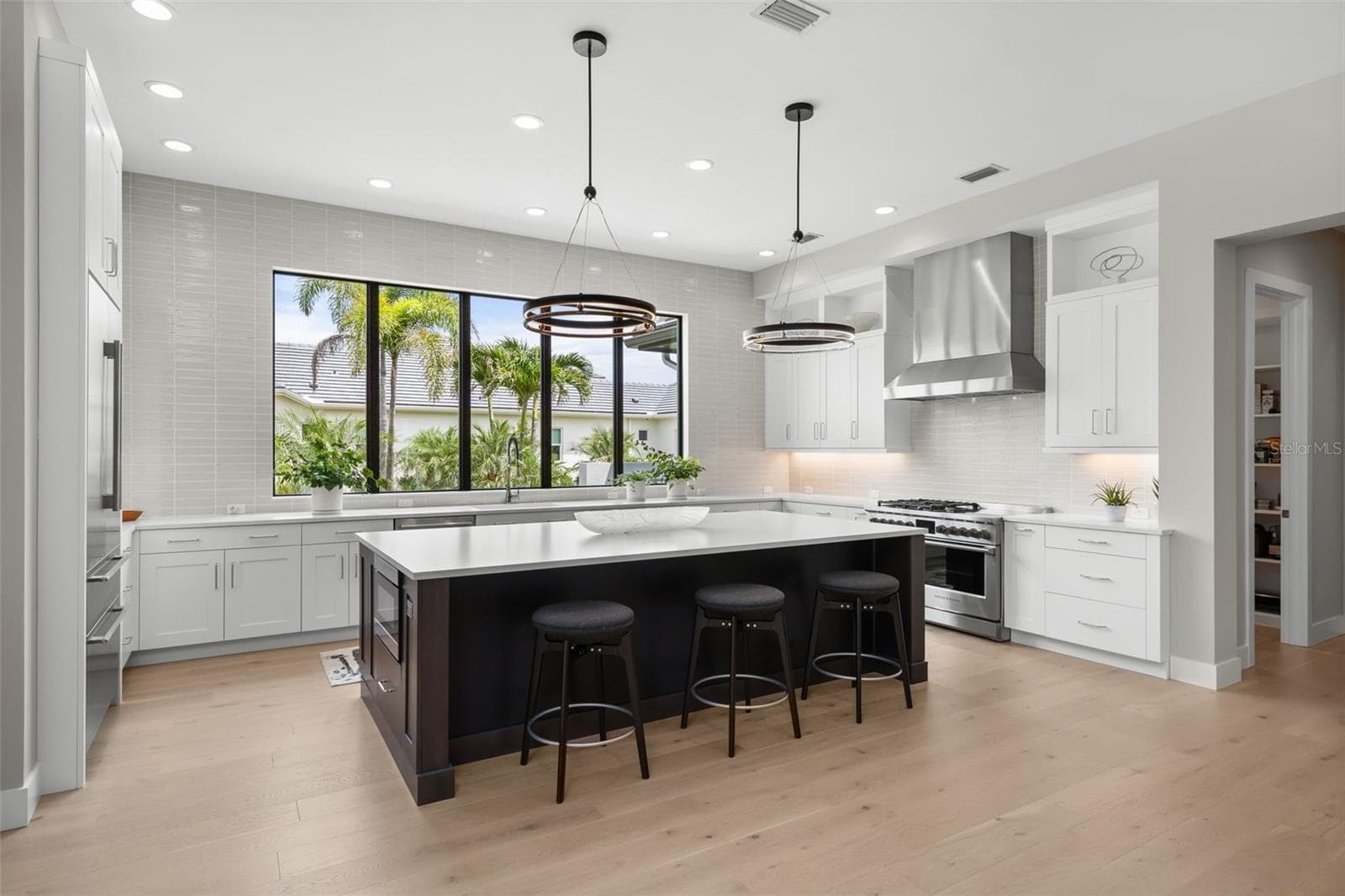 The large island has room for seating and lots of prep space for cooking and entertaining. - 11721 RIVE ISLE RUN, PARRISH
