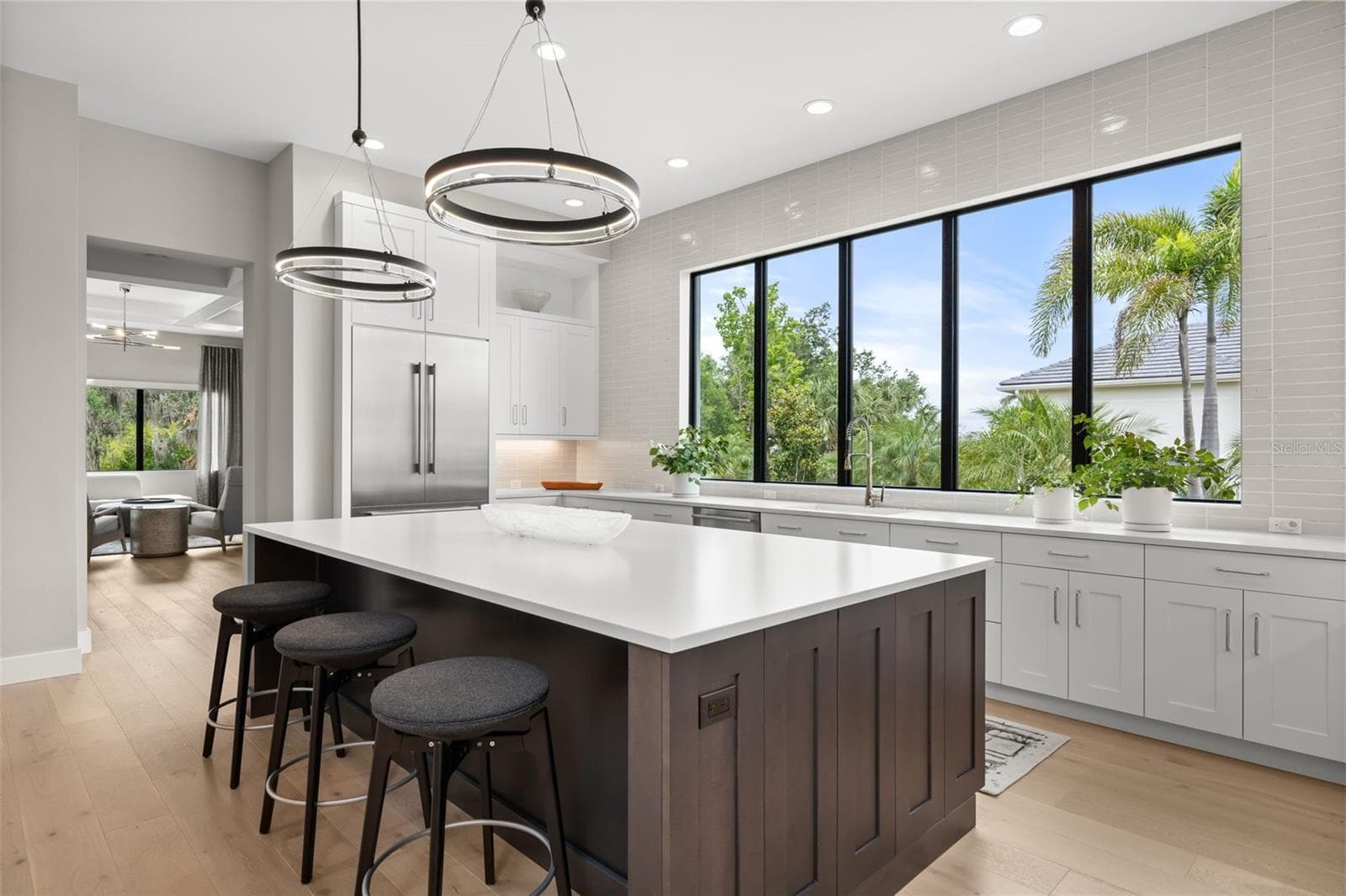 Oversized windows frame beautiful views of the lush tropical landscaping. - 11721 RIVE ISLE RUN, PARRISH