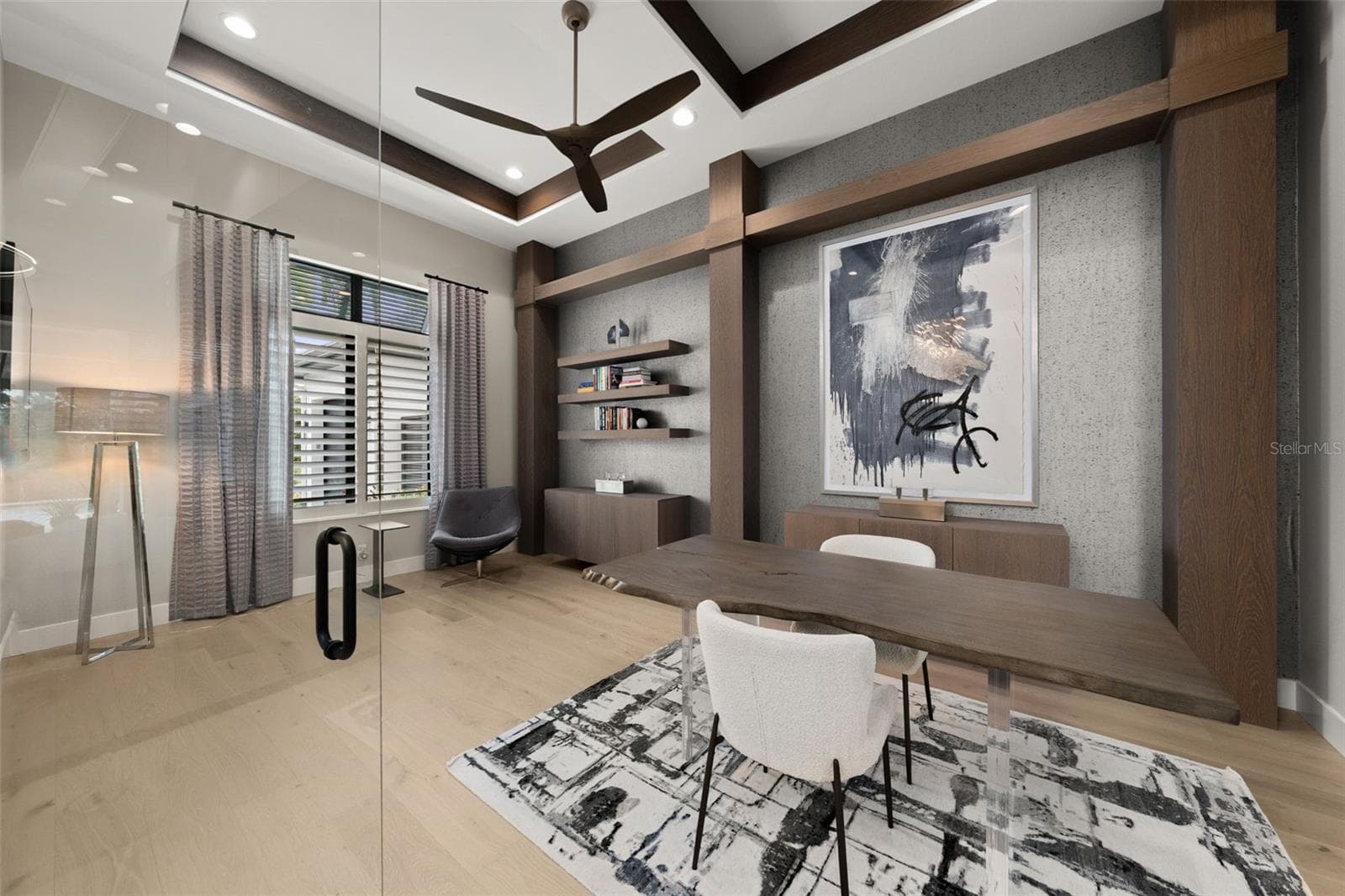 The den/office is enhanced by a wallpaper accent wall, wood columns, custom built-in cabinetry and double tray ceiling with wood detail. - 11721 RIVE ISLE RUN, PARRISH