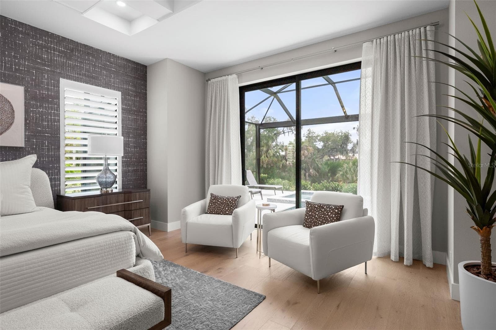 The sliding glass doors are adnored with custom drapery. - 11721 RIVE ISLE RUN, PARRISH