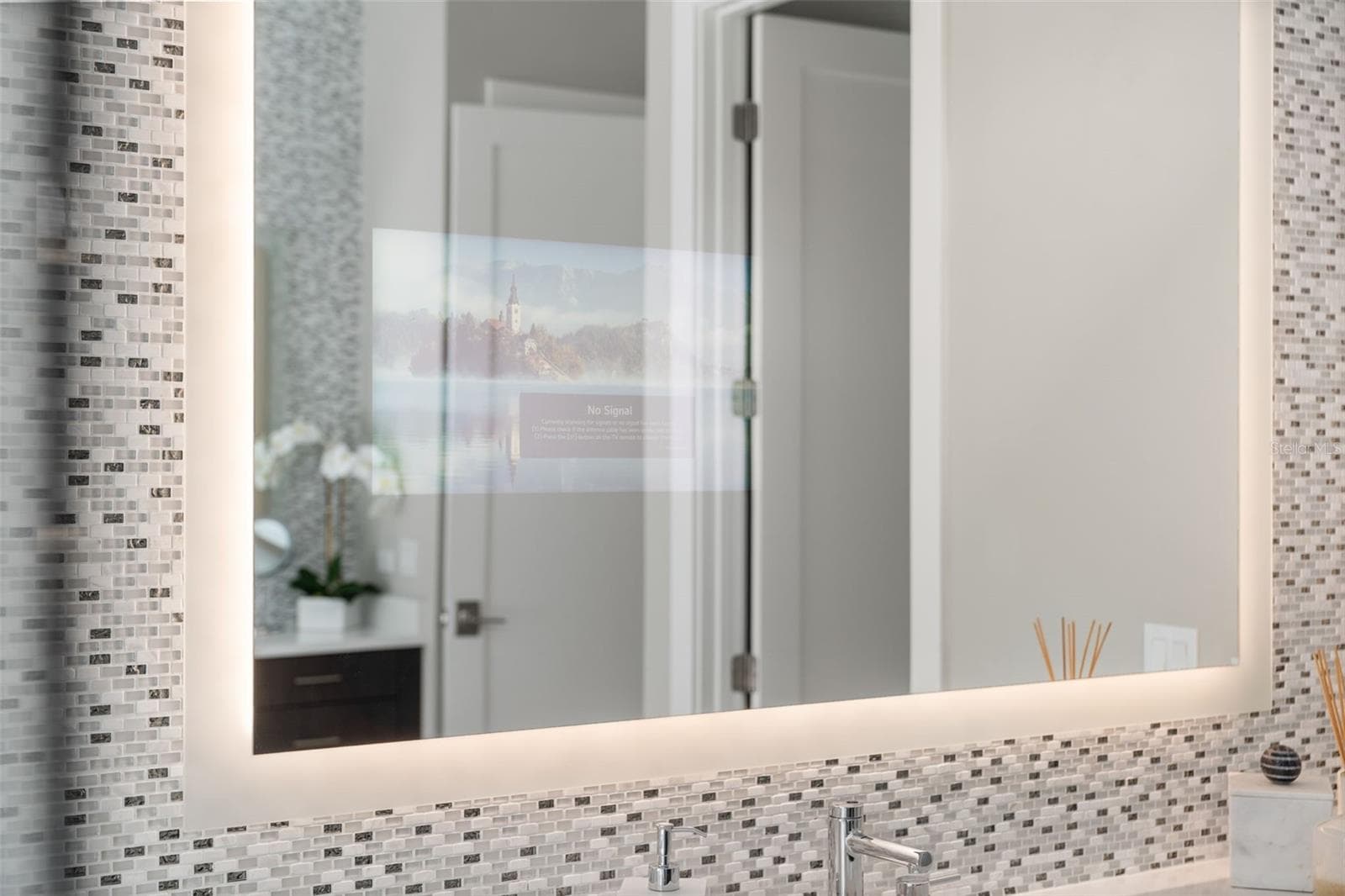 The backlit mirrors reflect off the tile work. - 11721 RIVE ISLE RUN, PARRISH