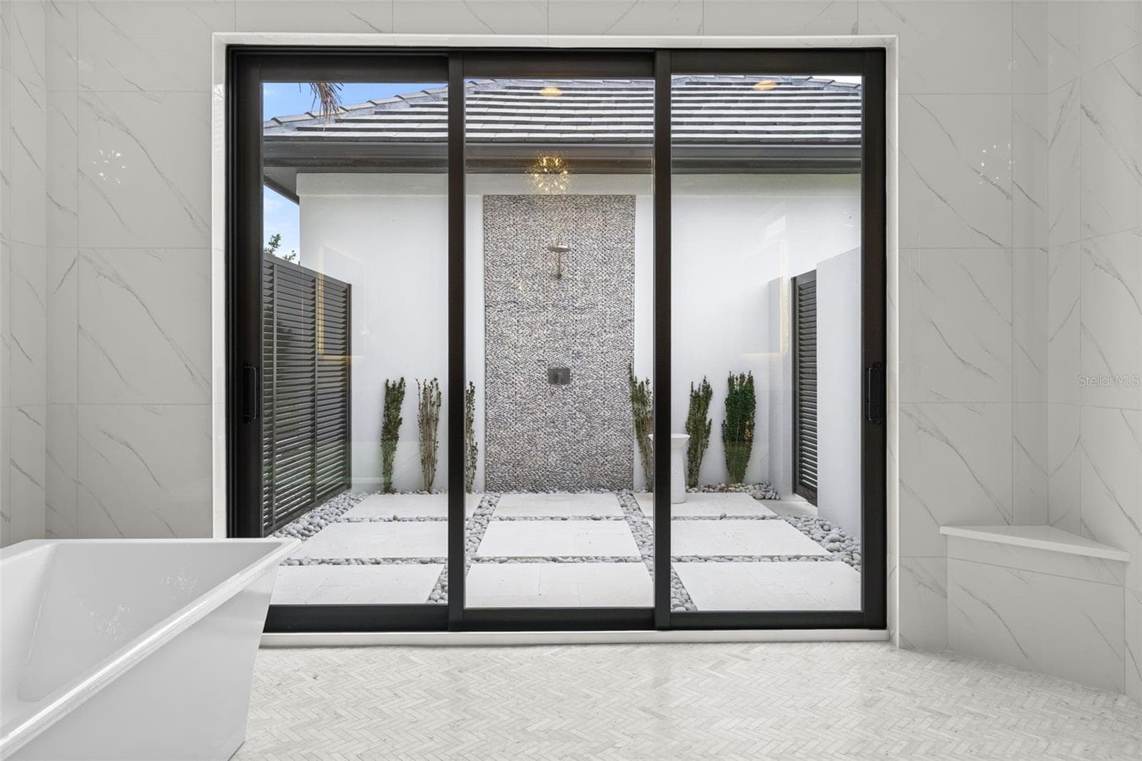 The sliding glass doors lead to the outdoor shower and private patio. - 11721 RIVE ISLE RUN, PARRISH