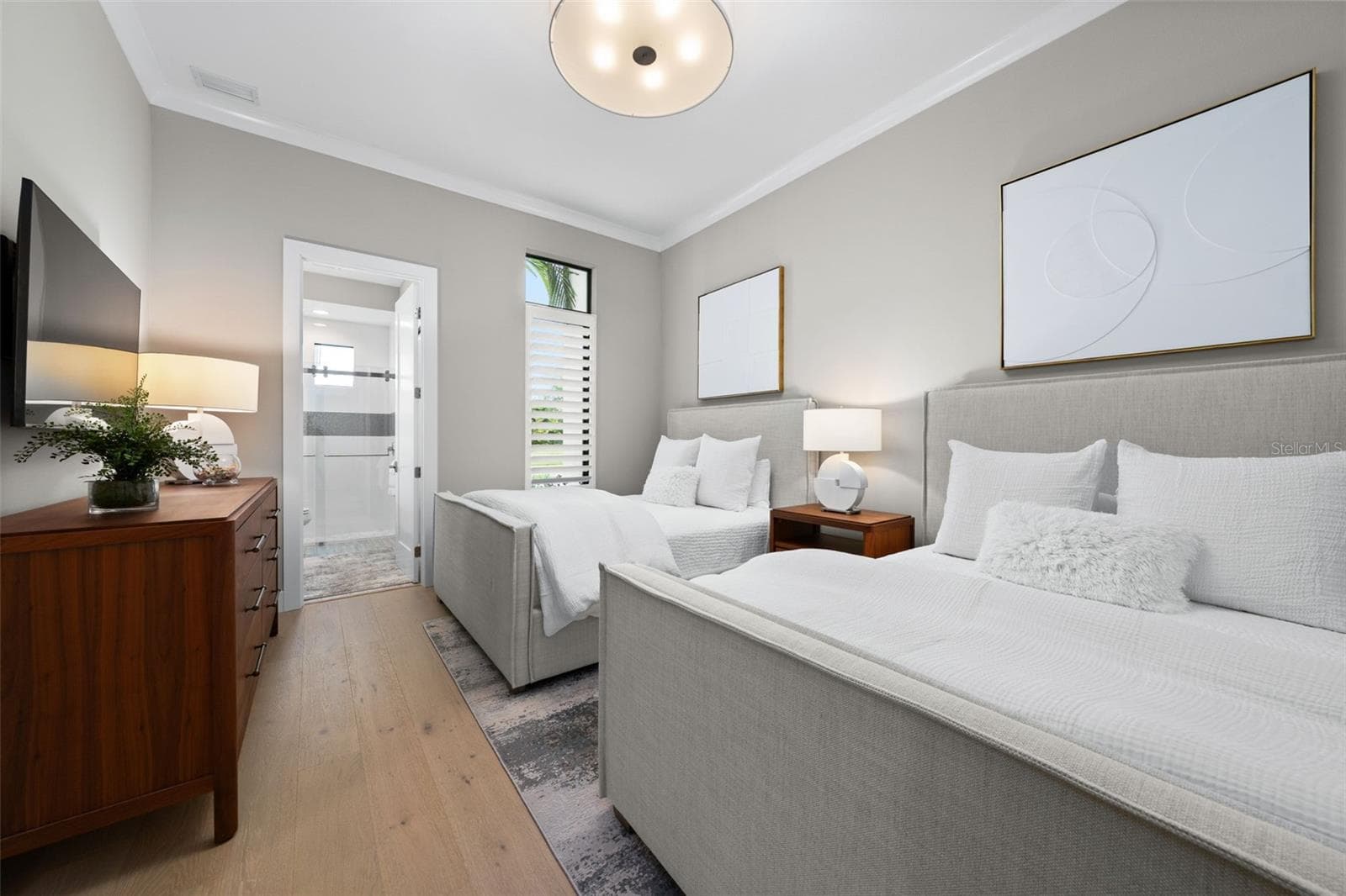 This guest room has crown molding, dual closets, accent lighting and an en-suite bathroom. - 11721 RIVE ISLE RUN, PARRISH
