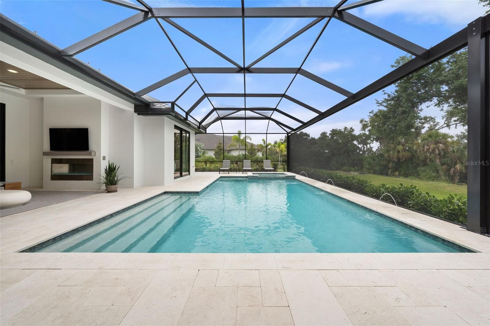 The resort-style saltwater pool and spa feature elegant water elements, an alarm system, and both solar and gas heating systems allowing for year-round enjoyment. - 11721 RIVE ISLE RUN, PARRISH