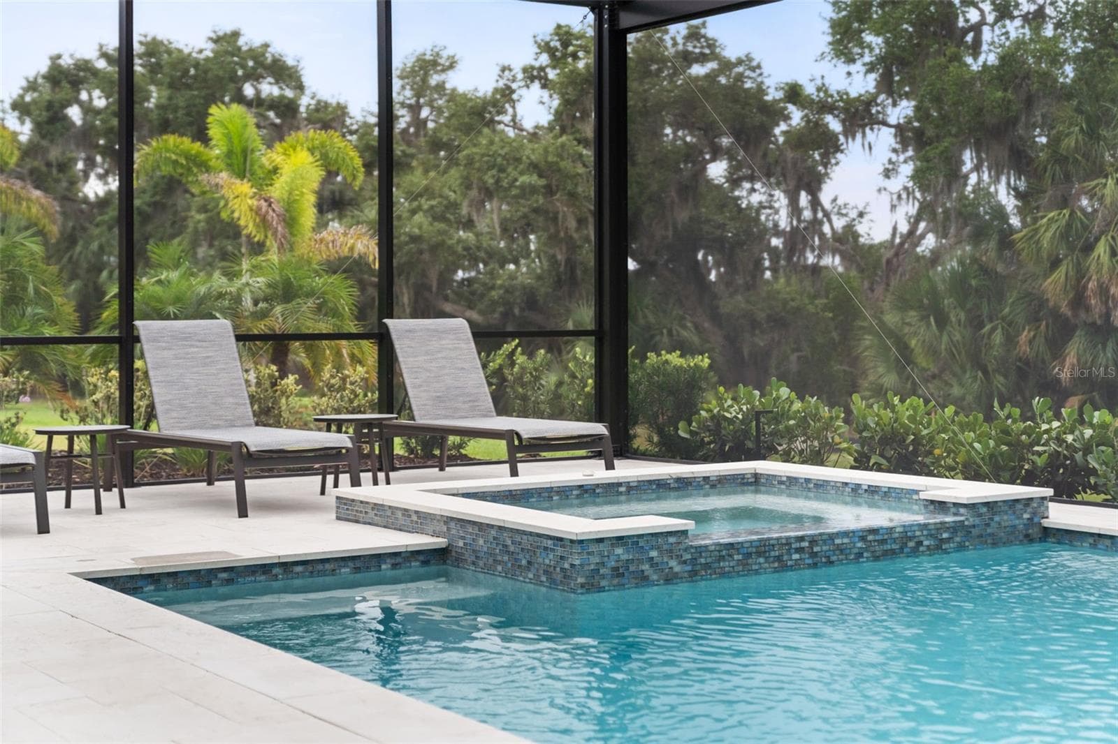The pool cage and deck were expanded to create more space for relaxing poolside. - 11721 RIVE ISLE RUN, PARRISH