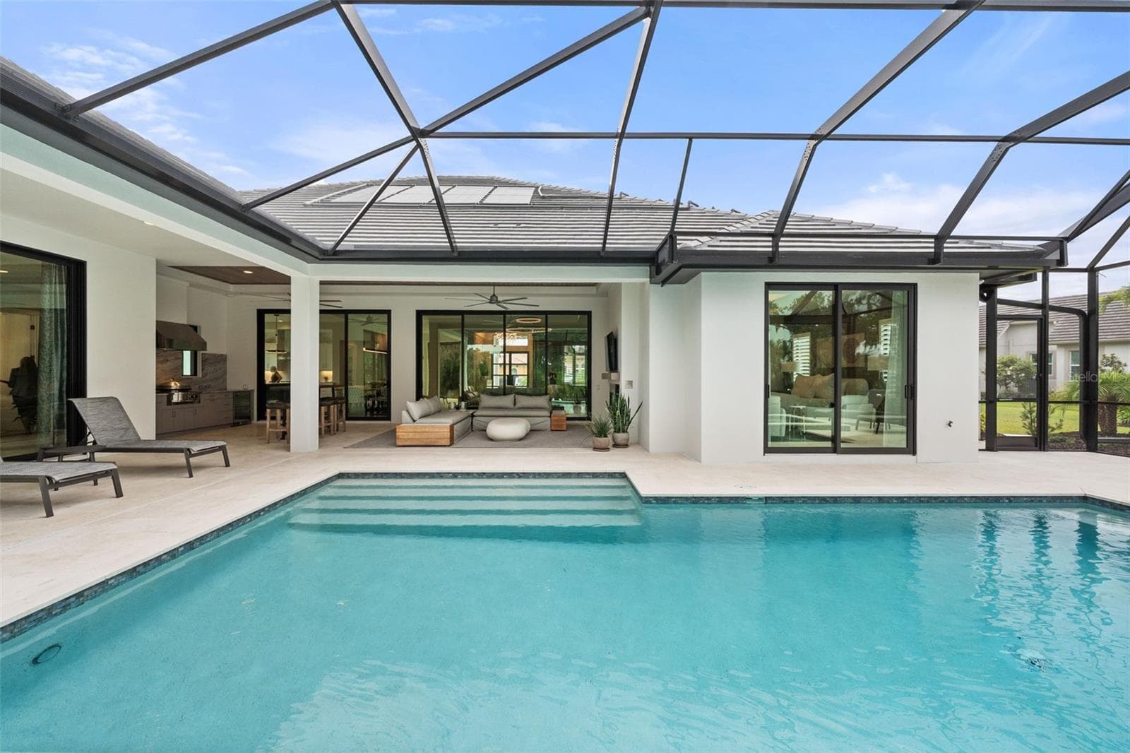 Elegant water features create a tranquil ambiance, filling the lanai with the soothing sounds of cascading water and enhancing the peaceful outdoor retreat. - 11721 RIVE ISLE RUN, PARRISH