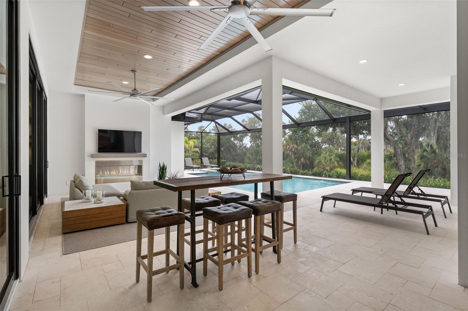 The covered lanai has wood ceilings and oversized ceiling fans. - 11721 RIVE ISLE RUN, PARRISH