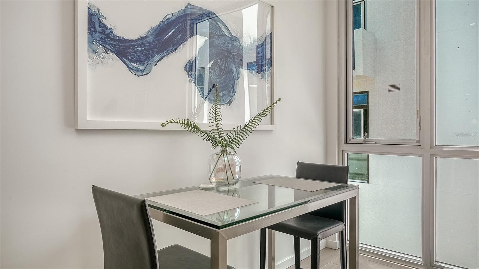 Energy-efficient impact glass walls maximize natural light and modern functionality. - 1350 5TH STREET #106, SARASOTA