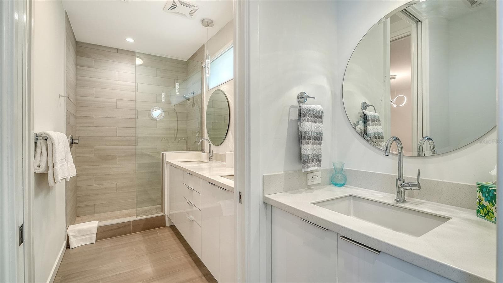 Modern bathroom with dual sinks and private toilet room provide bathing pleasure. - 1350 5TH STREET #106, SARASOTA