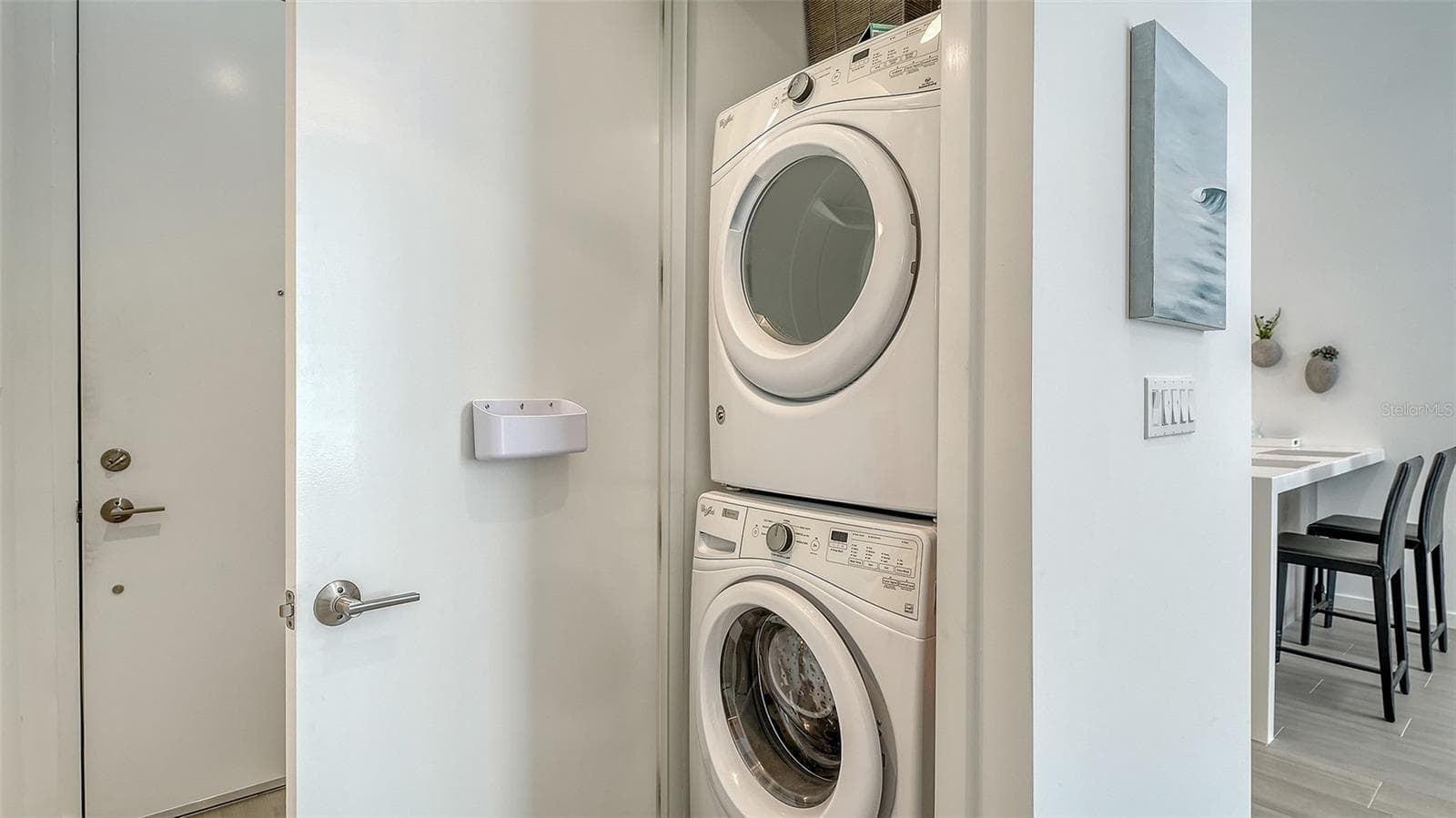 Conveniently stacked washer and dryer are ready for usage. - 1350 5TH STREET #106, SARASOTA