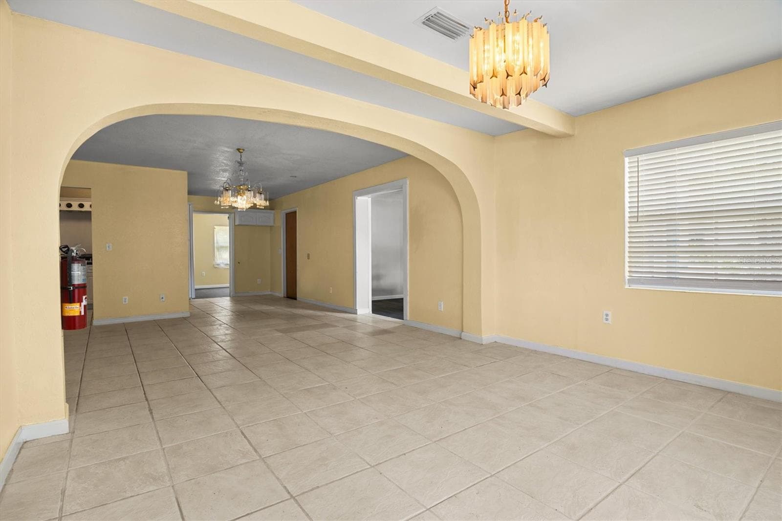 View of the living room and dining room from the front door. - 844 CHAMBERLAIN BLVD, WAUCHULA