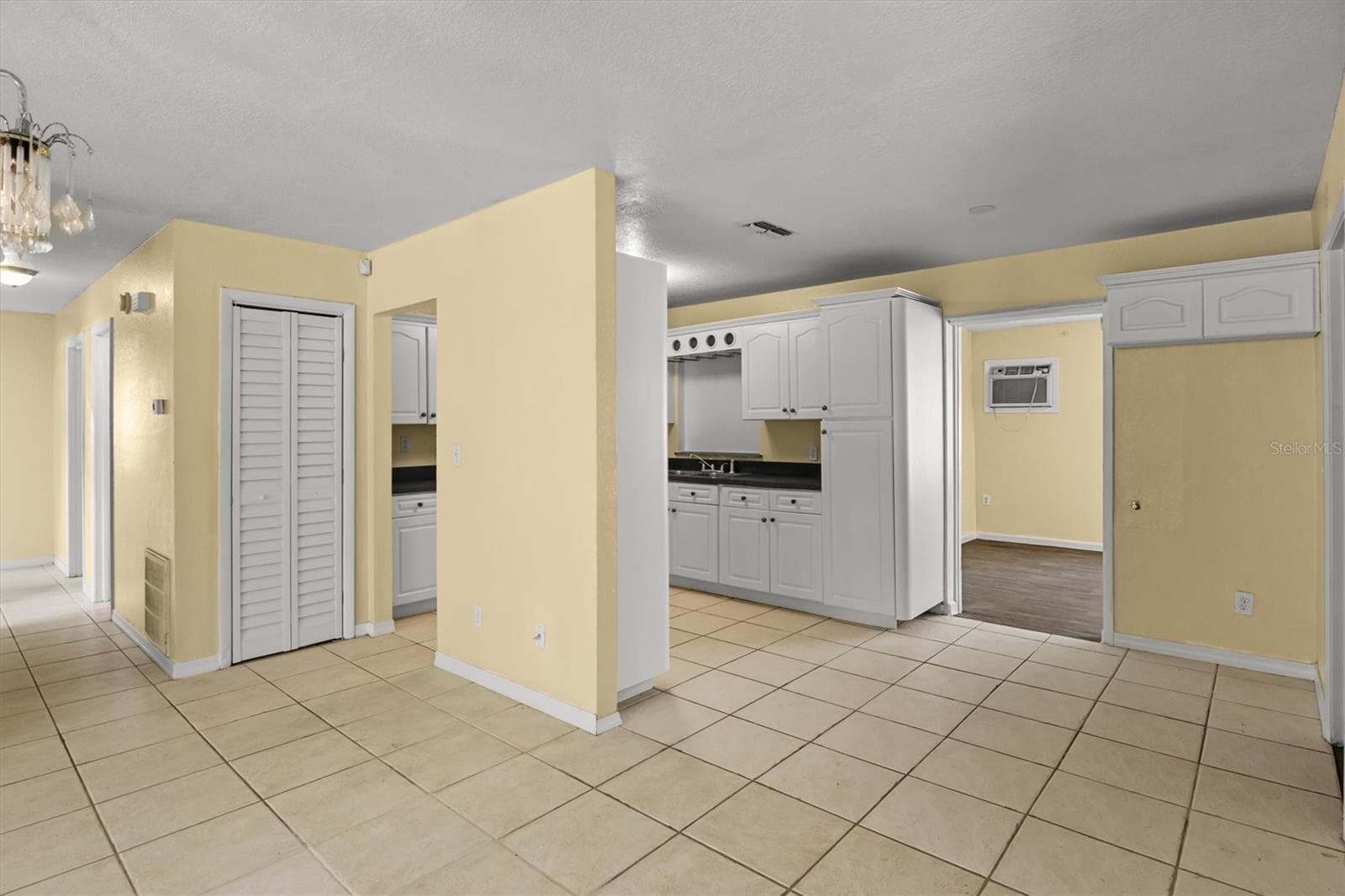 Kitchen from the dining area. - 844 CHAMBERLAIN BLVD, WAUCHULA
