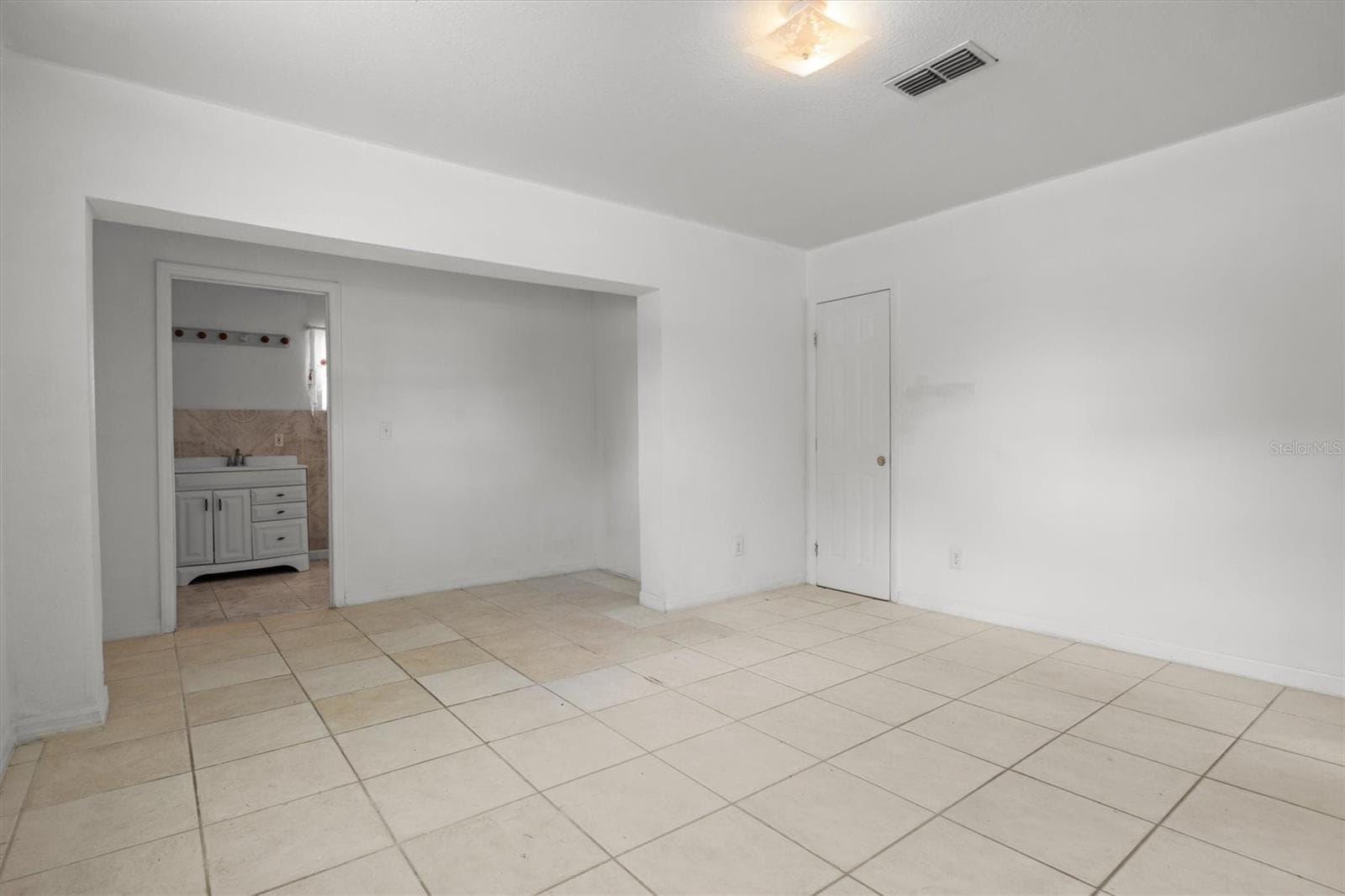 Another view of primary bedroom looking toward the primary bathroom - 844 CHAMBERLAIN BLVD, WAUCHULA