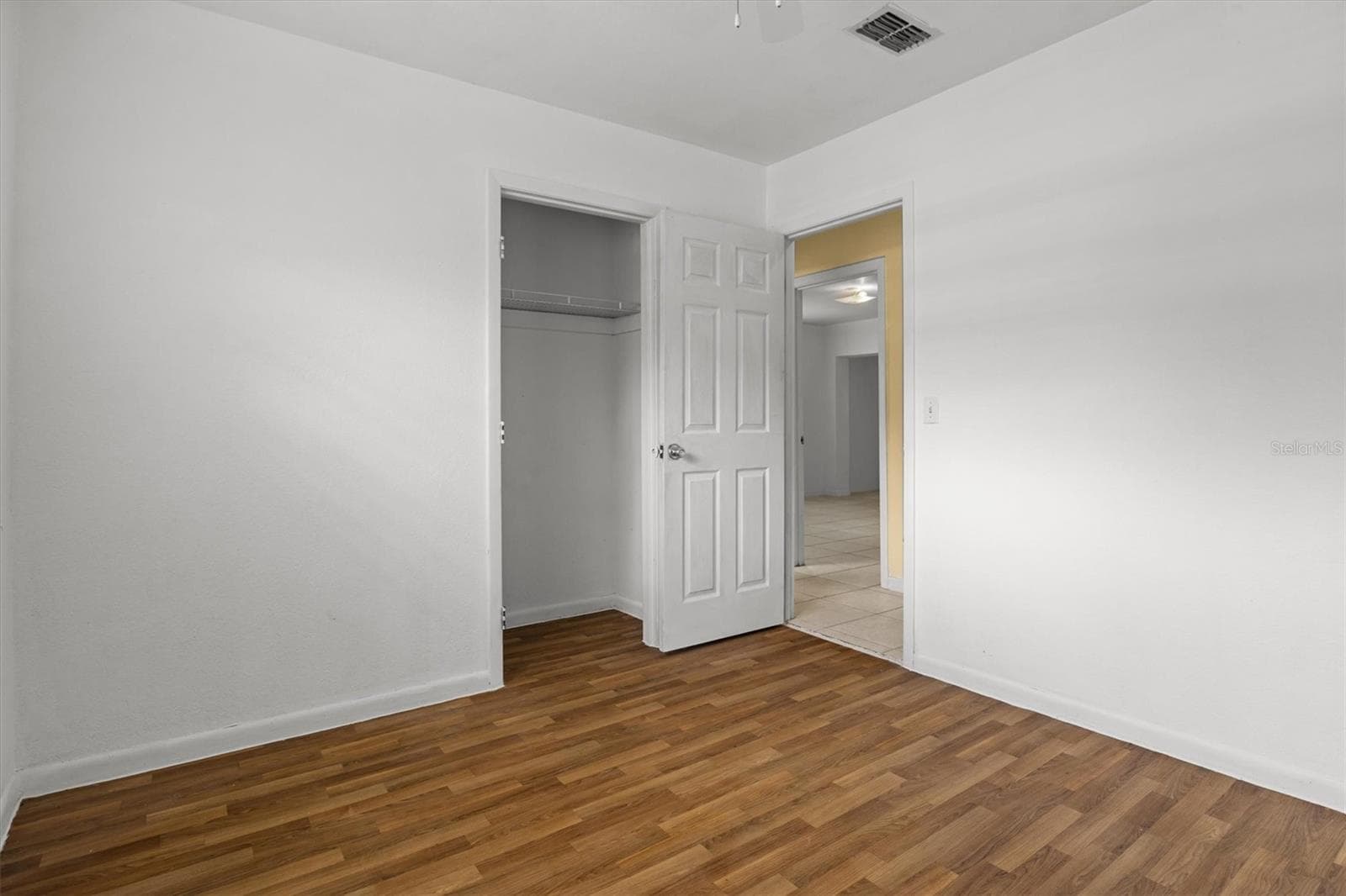 Guest bedroom with newer vinyl flooring - 844 CHAMBERLAIN BLVD, WAUCHULA