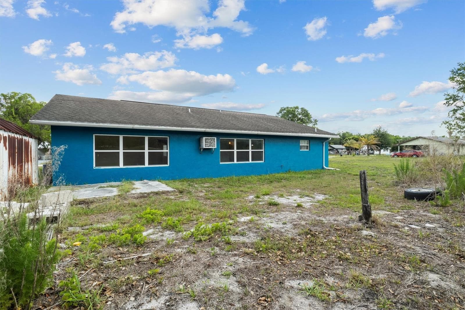 Back of the home with storage shed - 844 CHAMBERLAIN BLVD, WAUCHULA