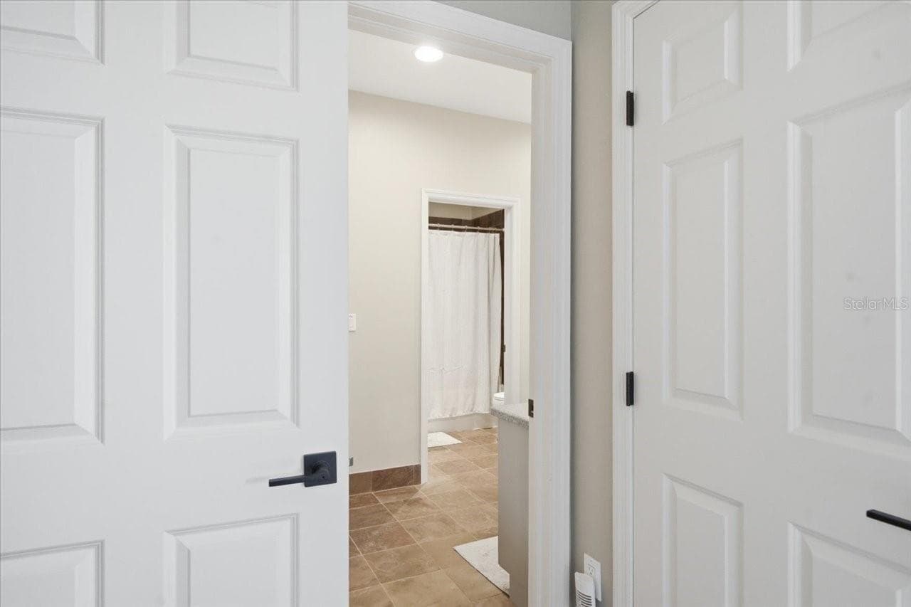 View of Jack and Jill bathroom from 3rd bedroom- walk in closet on right. - 1130 S FLORIDA AVE, TARPON SPRINGS