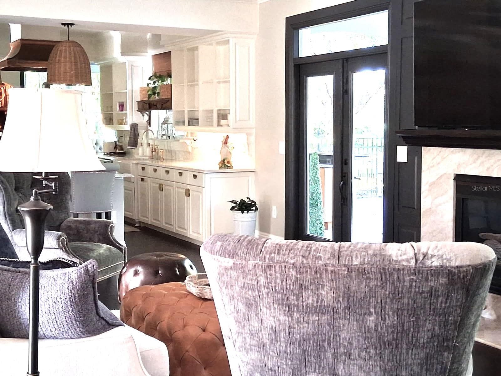 Views to the enchanting Yard and Golfcourse from the Formal Living Room Open to the Kitchen - 3171 DICK WILSON DR, SARASOTA