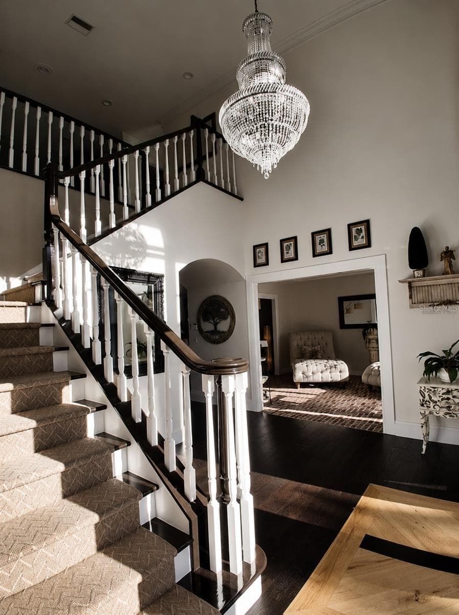 Walk into an Elegant Foyer with New Large Crystal Chandleir, Custom Stair carpet and New Hardwoods and New Front Foor - 3171 DICK WILSON DR, SARASOTA
