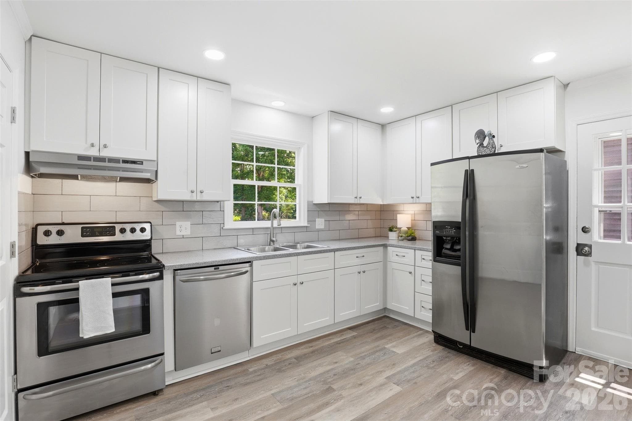 New shaker cabinets are featured in this updated kitchen - 9624 Central Drive, Mint Hill