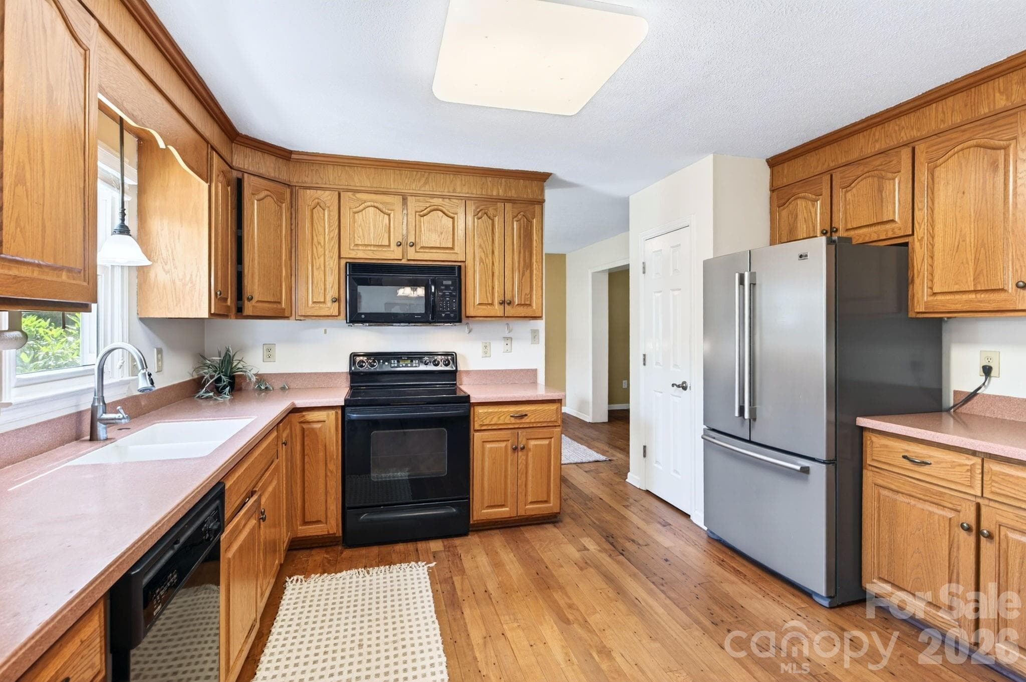 Spacious kitchen with oak cabinets and Corian countertops - Asheville