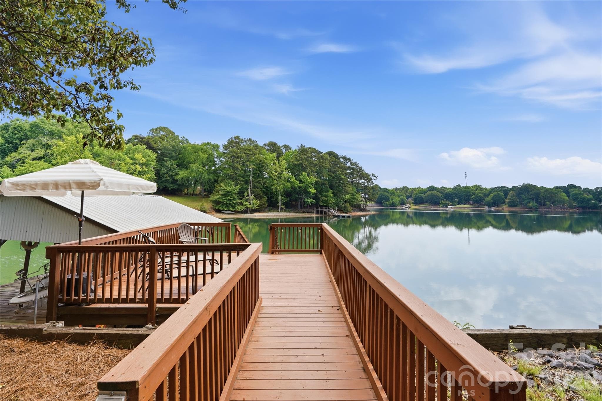 Lakeside deck and a covered dock with lift plus floating dock provide direct access to Lake Wylie. - 1113 Palmyra Drive, Tega Cay