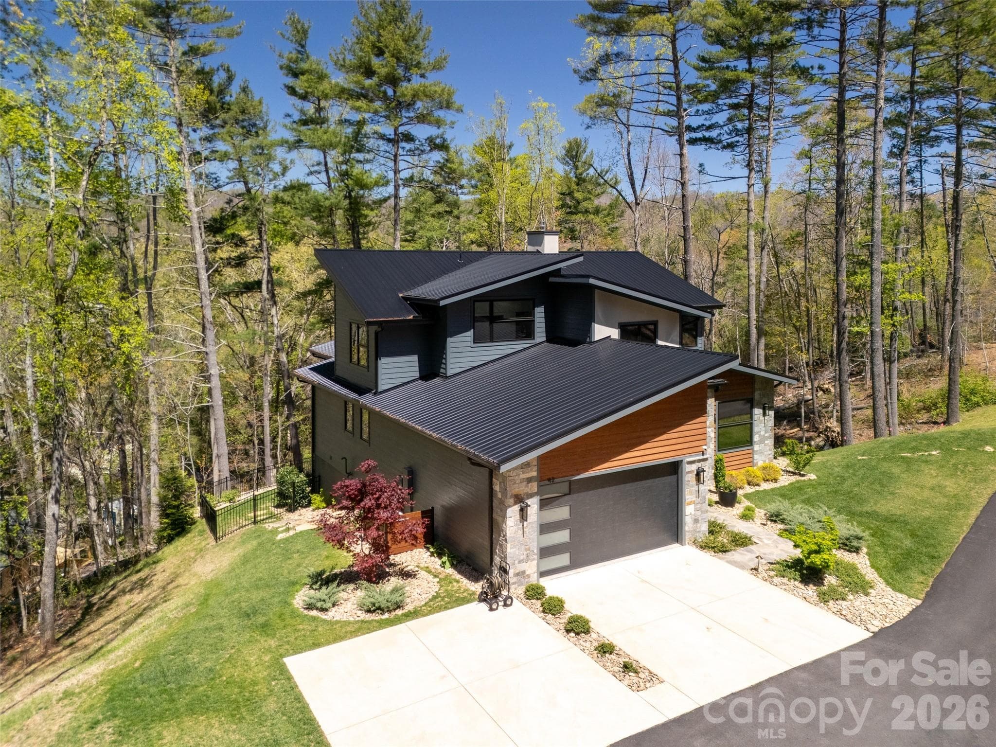 2-car garage and 4 car parking. Plenty of room to expand garage for additional vehicles, workshop, artist studio, storage, etc., if ever desired. Glimpse of whole home generator can be seen adjacent to house (behind japanese maple). - Asheville