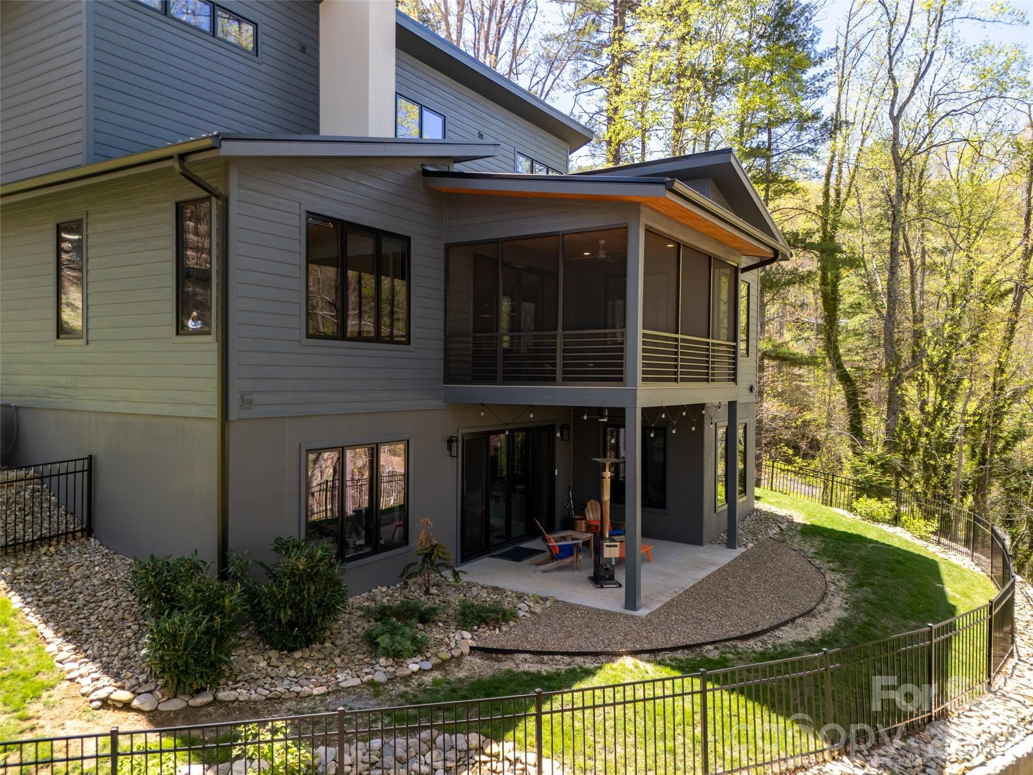 Dual-tiered exterior living/entertaining spaces and newly fenced rear yard. - Asheville