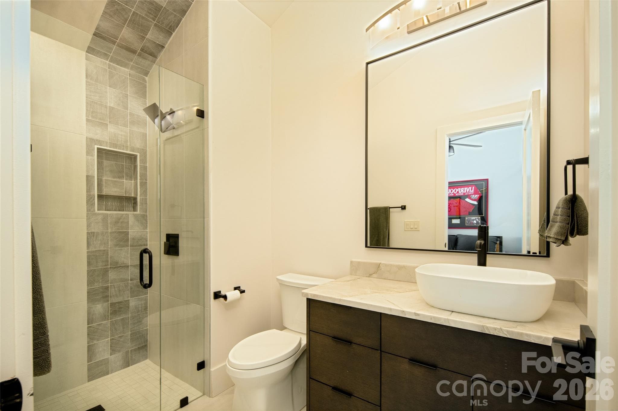 First of two full baths on second floor features vanity with vessel sink and custom-tiled shower. - Asheville