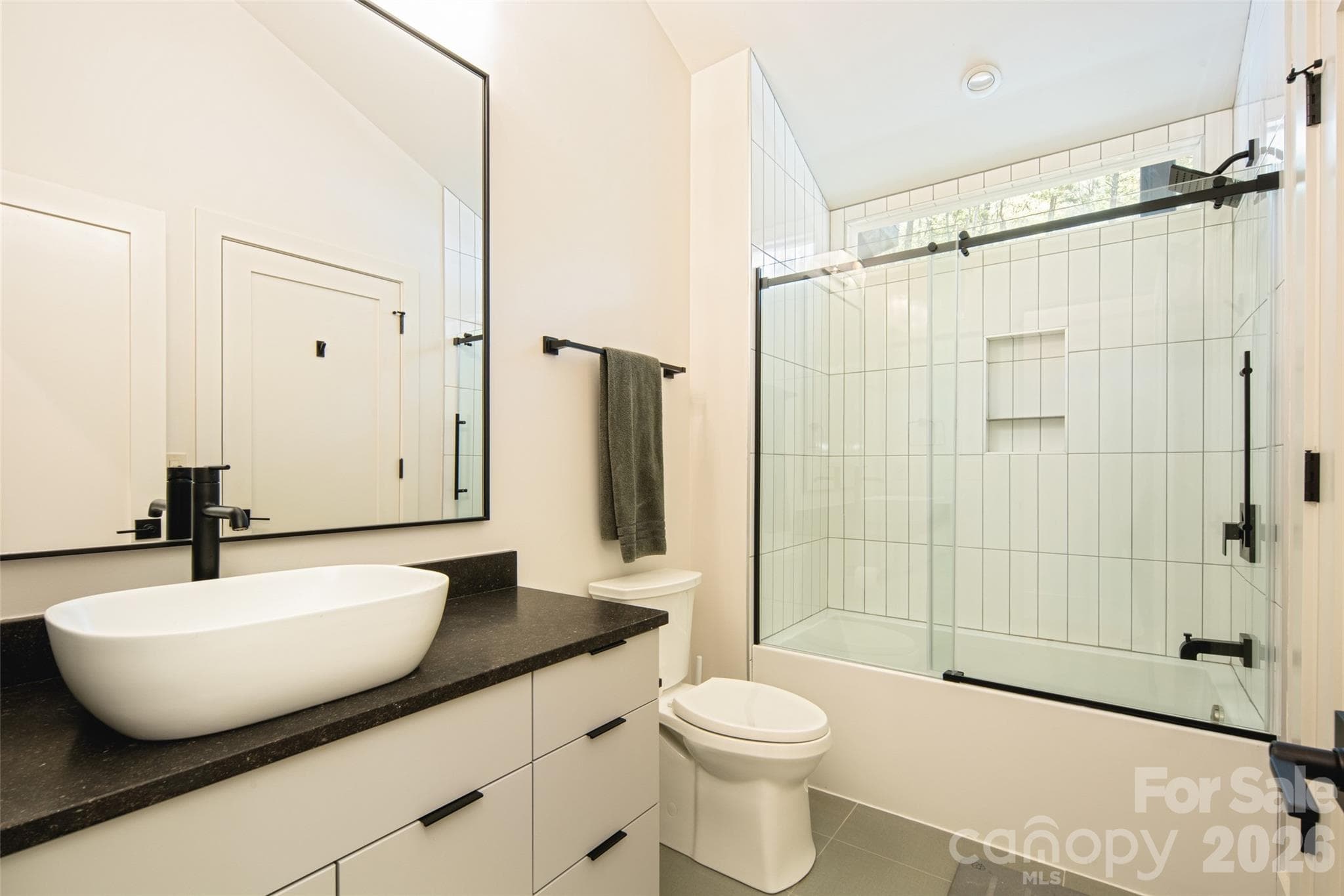 Second full bath on second floor features vanity with vessel sink and shower & tub combo. - Asheville