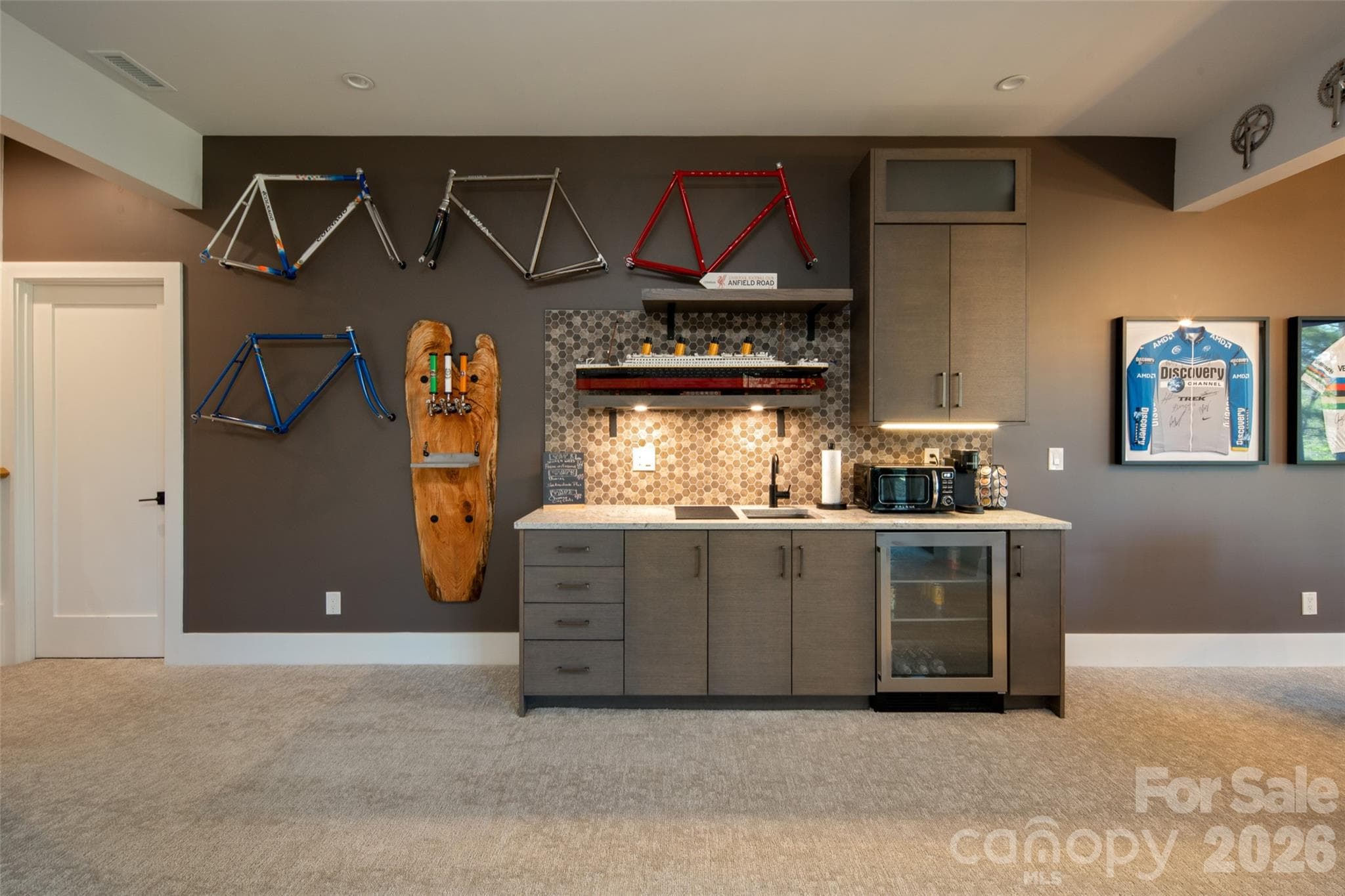 You'll enjoy this custom wet bar area with BUILT-IN custom beer "station" with EdgeStar BR7001 kegerator and three Perlick 650SS flow control valves/taps and custom behind-wall installation. The perfect on-demand brews at the perfect temperatures! Wetbar with beverage/wine fridge and floating shelving. - Asheville