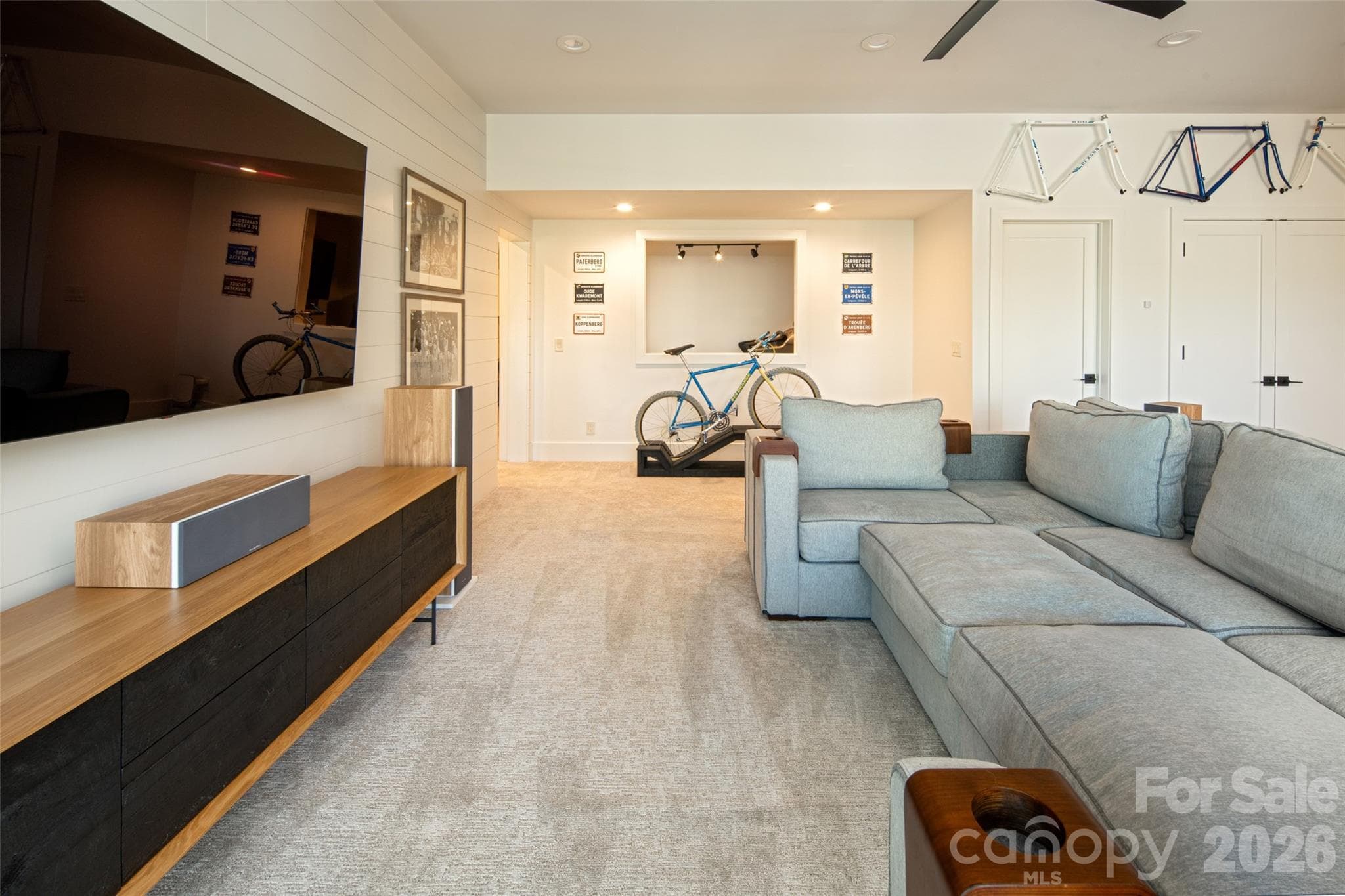 Family room adjoins a perfect flex space with passthrough (currently used as a home gym) and 2nd primary ensuite bedroom/bath and yet another office space (currently used for children's gaming stations!). - Asheville