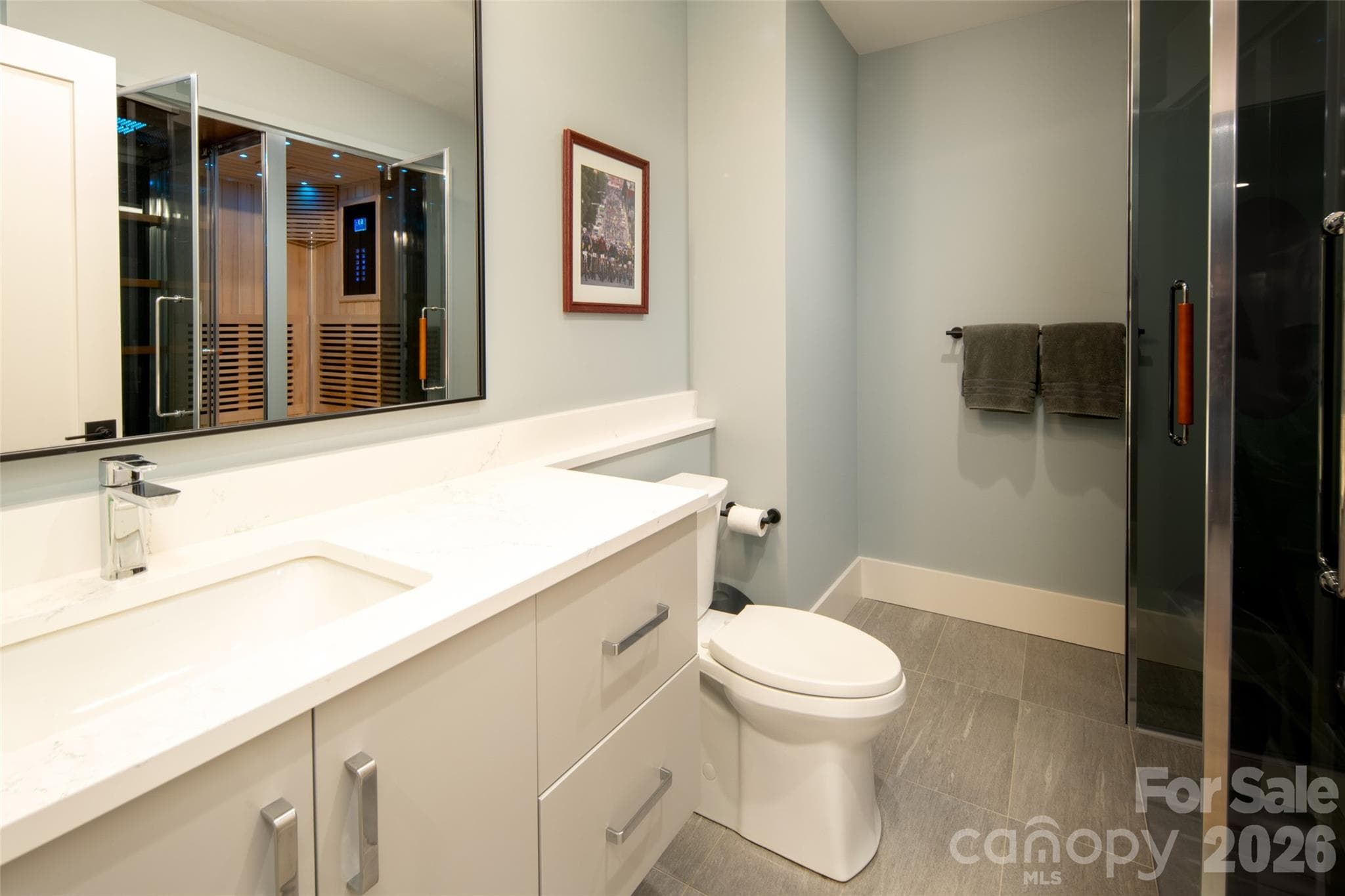 Ensuite bath for lower level primary can also be accessed via hallway for guests while entertaining. - Asheville