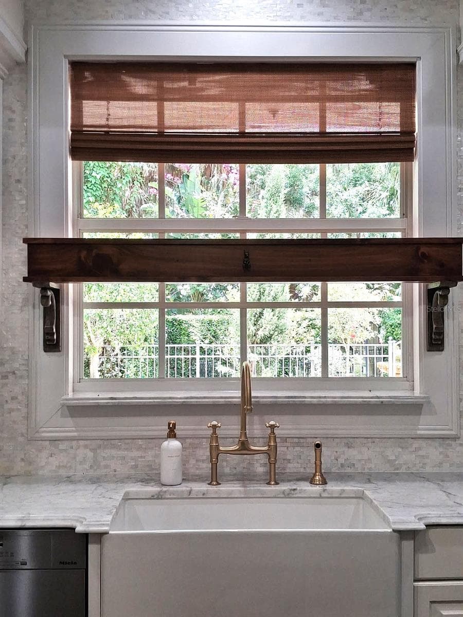 New Farmhouse Sink & New Bridge Faucet. Beautiful Wood Shelf And Custom Bamboo Window Blinds. View to Formal English walled garden with Fruit Trees & Fountain - 3171 DICK WILSON DR, SARASOTA